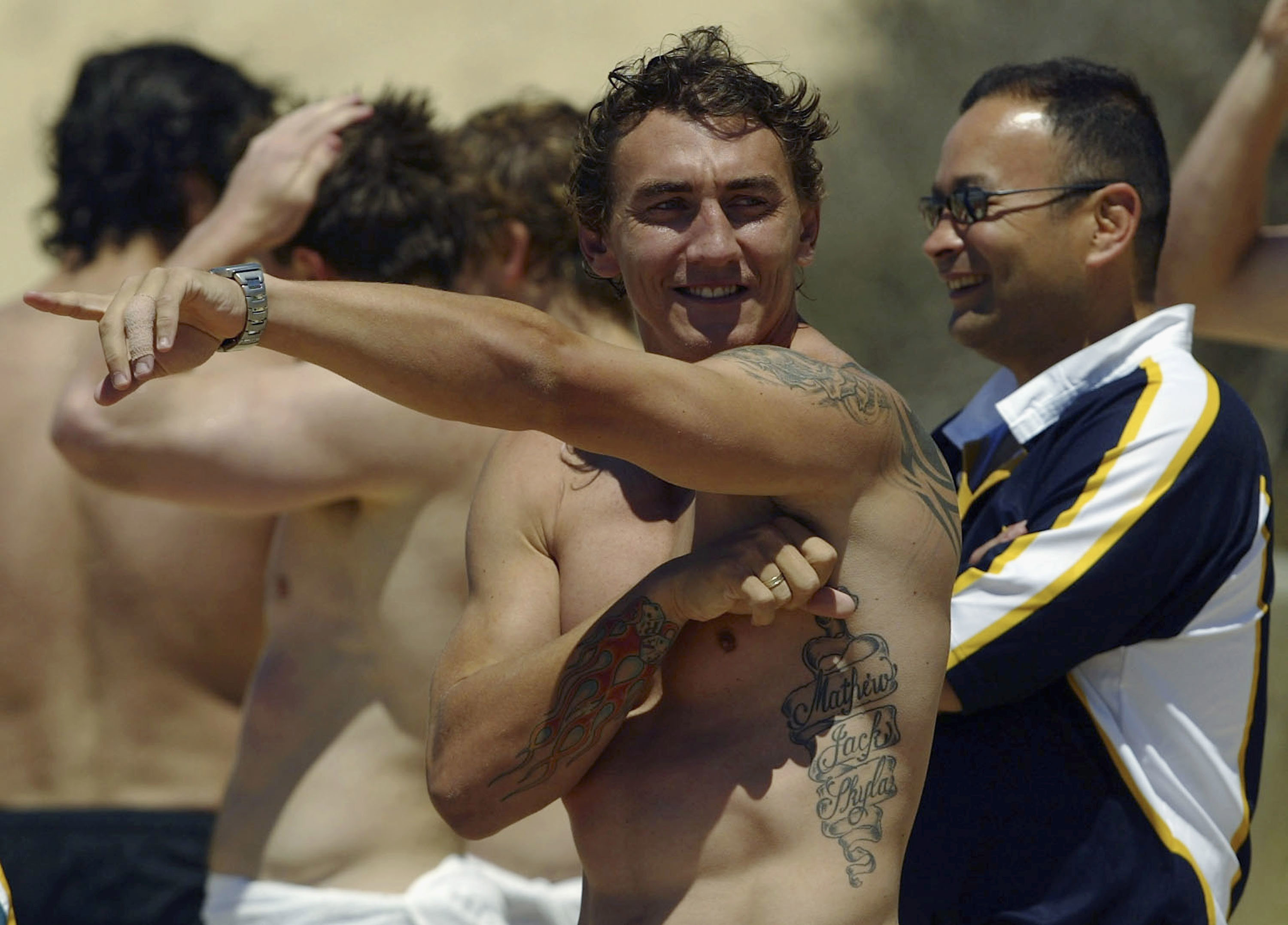 Mat Rogers and Eddie Jones enjoy the sun at Diggers Beach in Coffs Harbour.