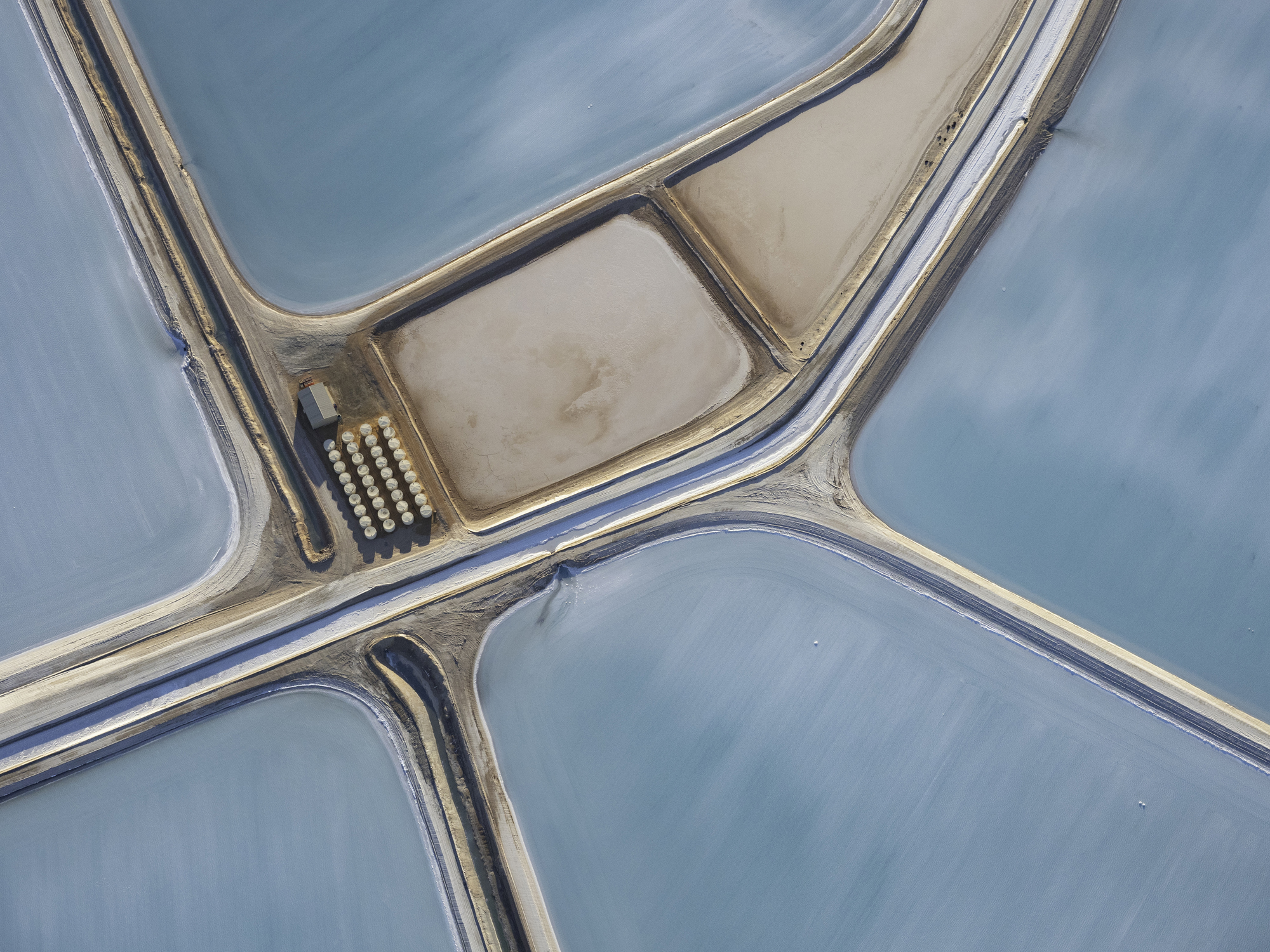 Aerial photo taken from a small plane showing a patchwork quilt of the salt works below at Useless Loop, Shark Bay, Western Australia