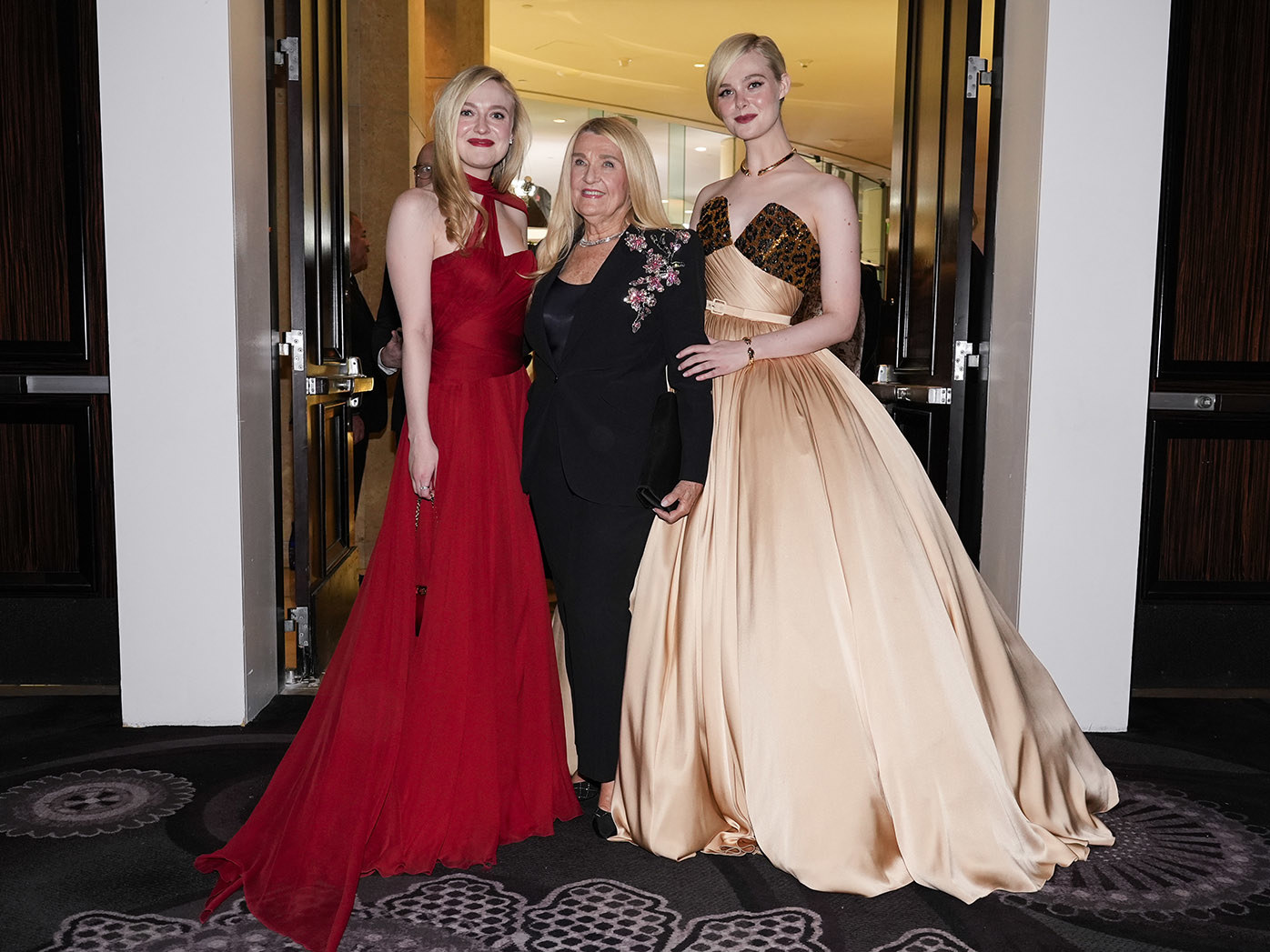 Dakota Fanning, left, and Elle Fanning, right, pose with their grandmother at the 82nd Golden Globes on Sunday, Jan. 5, 2025, at the Beverly Hilton in Beverly Hills, Calif. 