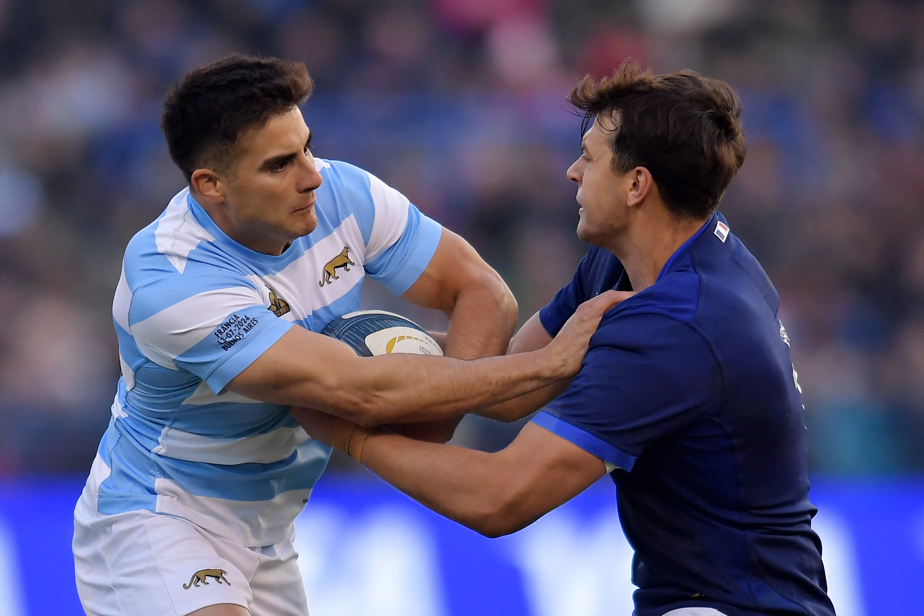 Tomas Albornoz of Argentina hands off Antoine Frisch of France.