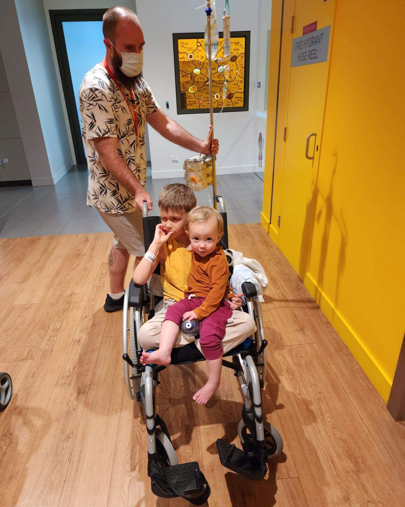 Oliver with his sister and dad, Nathan, in hospital. 