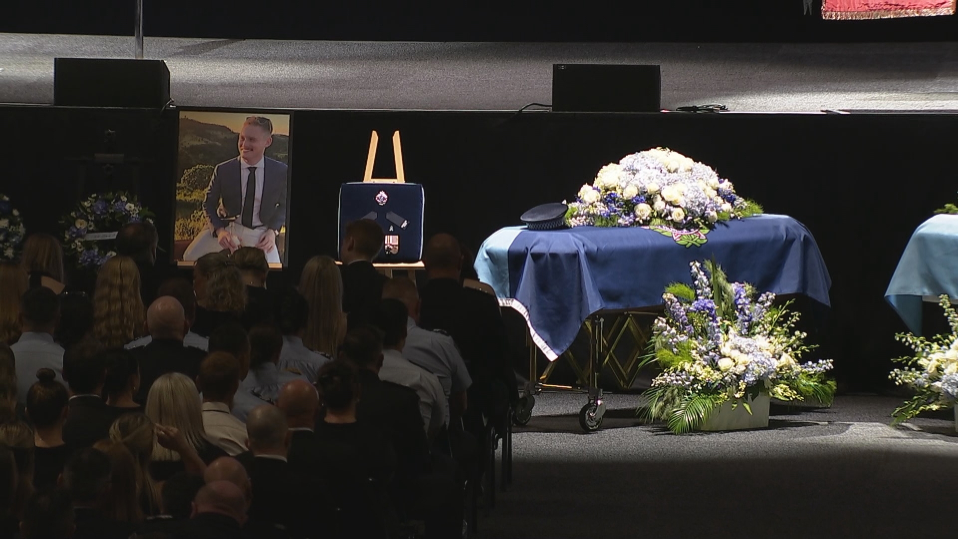 Coffins of Constable Matthew Arnold and Rachel McCrow at the public memorial.