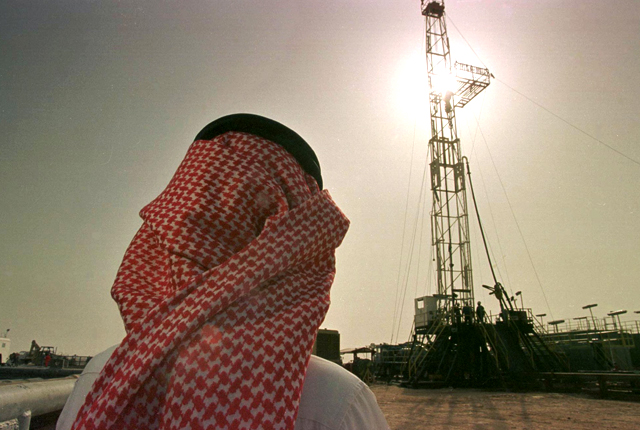 An official of the Saudi oil company Aramco watches progress at a rig at the al-Howta oil field near Howta, Saudi Arabia. The kingdom's plan to sell part of the company is part of a wider economic overhaul aimed at raising new streams of revenue for the oil-dependent country, particularly as oil prices struggle to reach the $75 to $80 price range per barrel analysts say is needed to balance Saudi Arabia's budget.