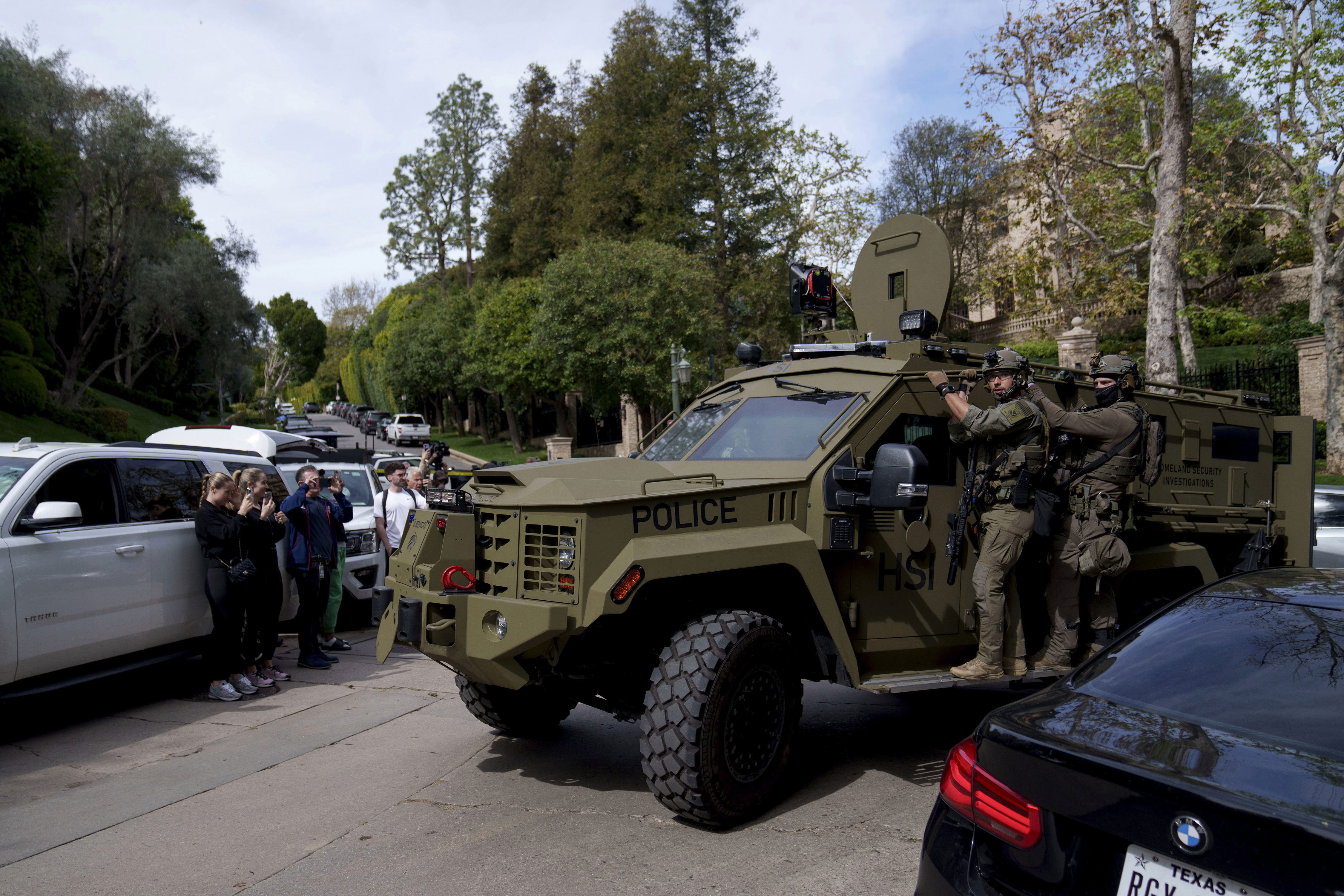 A law enforcement vehicle rumbles up to a a Beverly Hills property belonging to Sean 'Diddy' Combs.