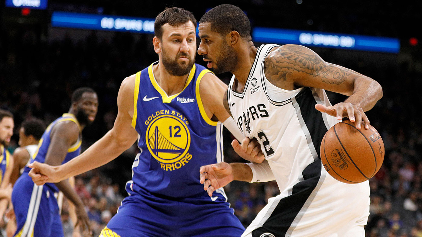 Spurs power forward LaMarcus Aldridge (12) dribbles the ball as Golden State Warriors center Andrew Bogut 