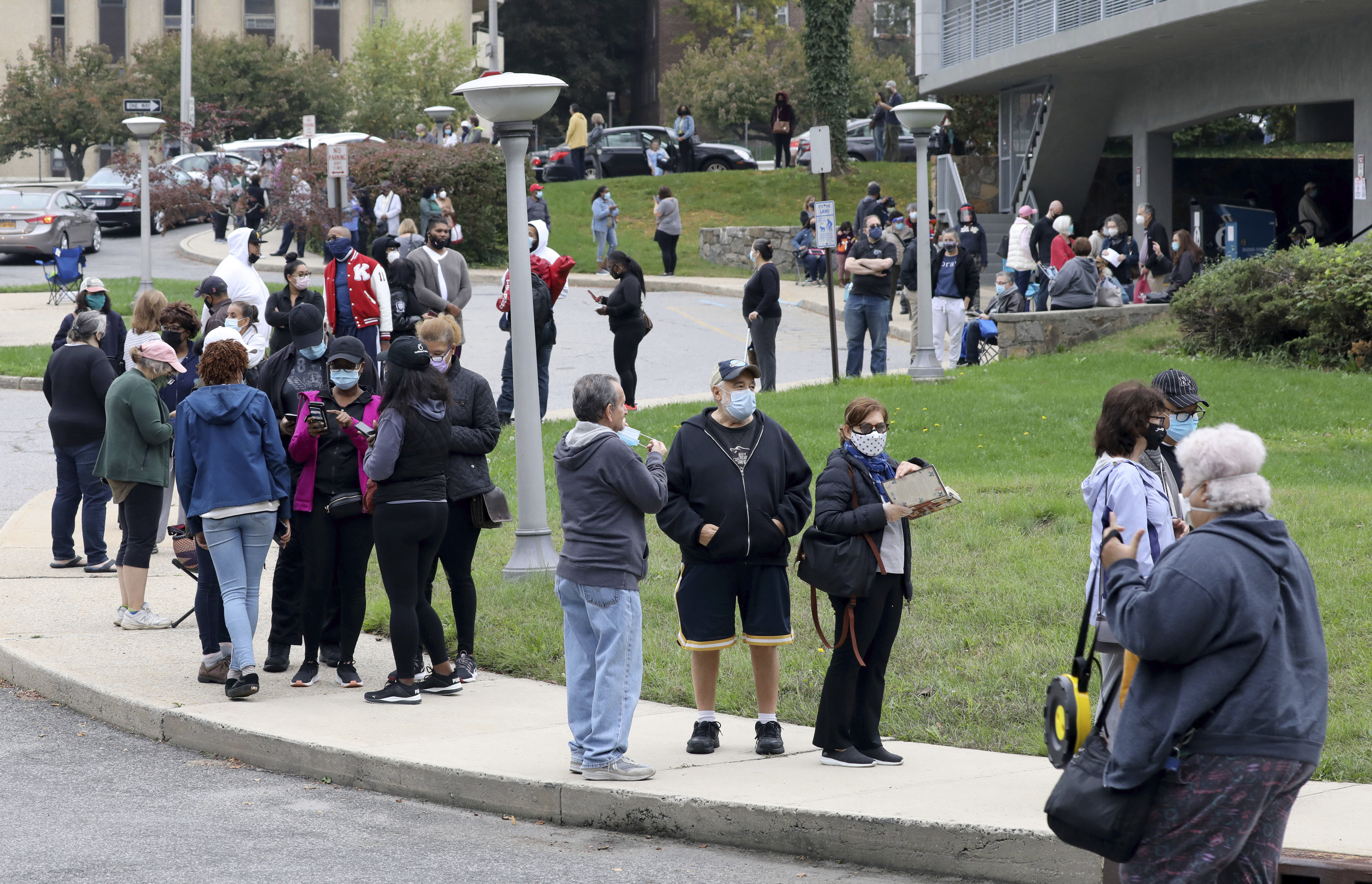 Voters line up in front of the Yonkers Public Library in Yonkers, as  the first day of early voting in the presidential election begins across New York state.