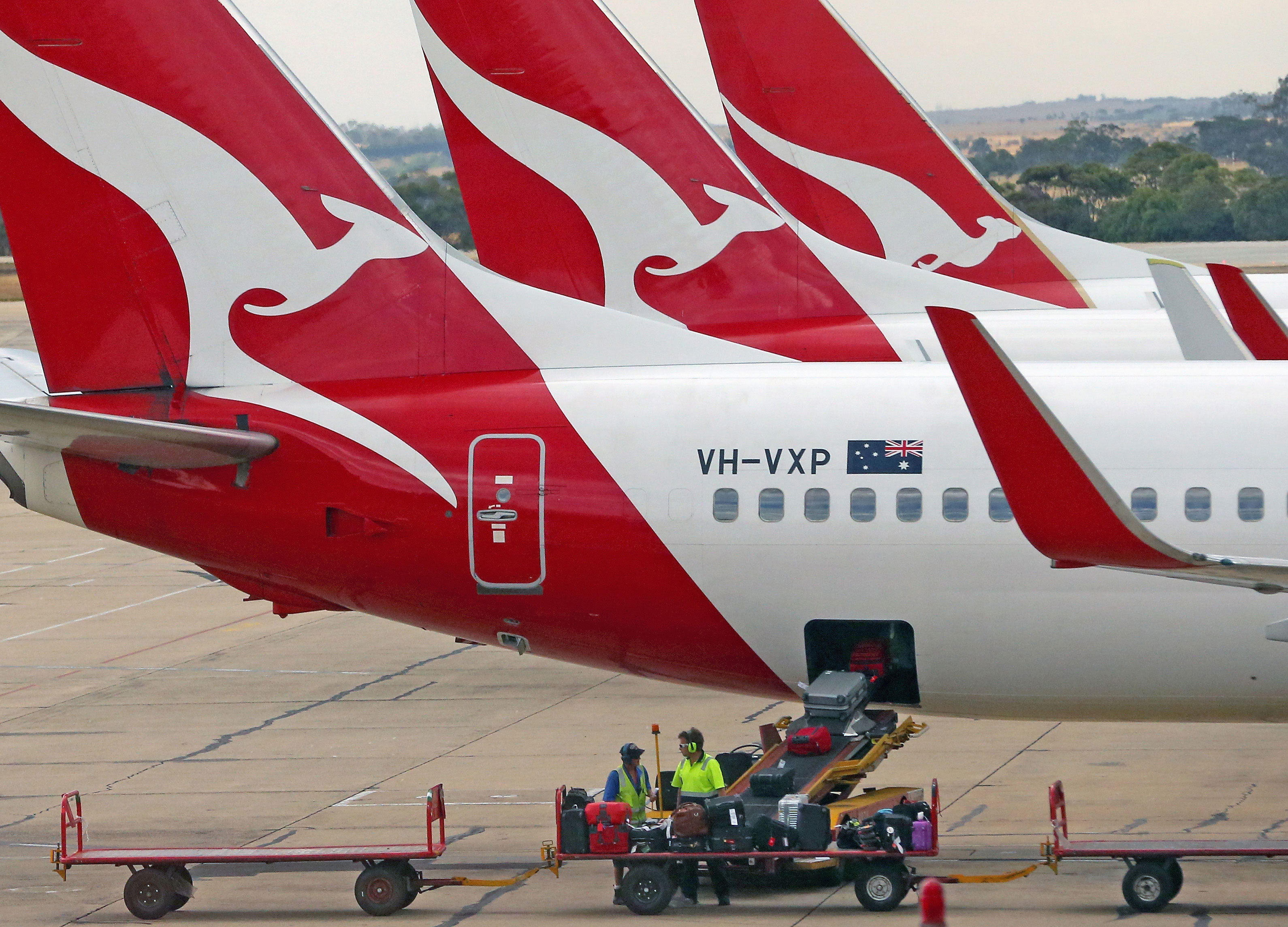 Baggage is loaded onto a Qantas jet at Melbourne Tullamarine Airport. 