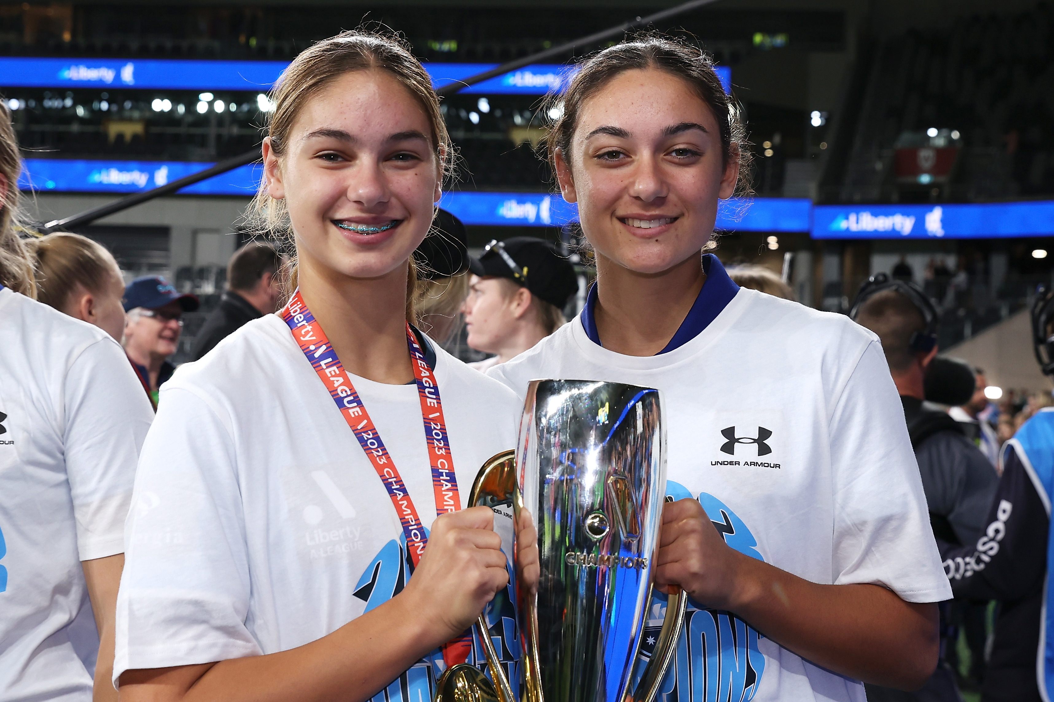 Sisters Indiana Dos Santos and Jynaya Dos Santos of Sydney FC pose with the A-League Women's championship trophy.