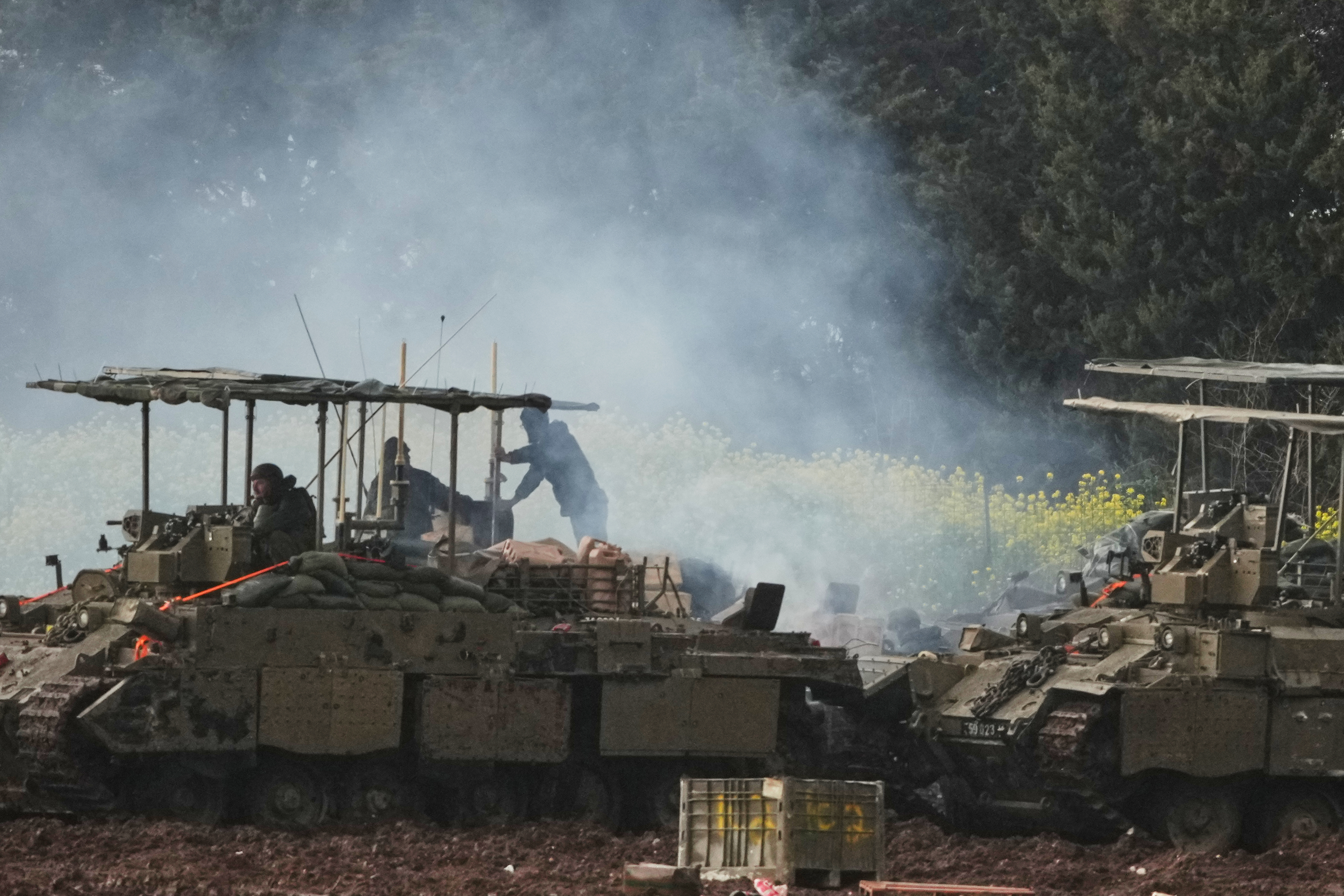 Israeli soldiers atop an APC in northern Israel