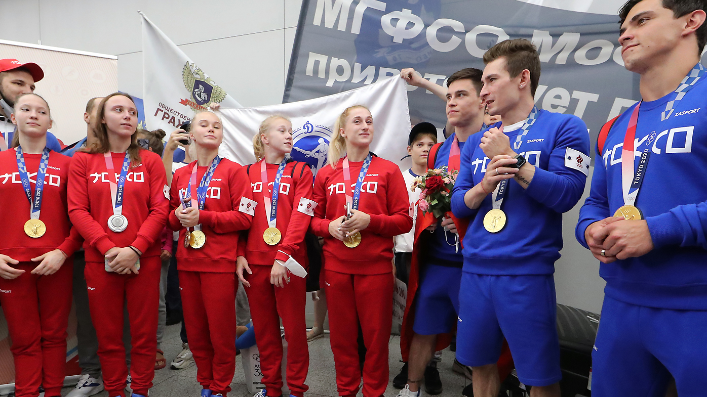 ROC athletes pose for a group photograph at Sheremetyevo International Airport upon their arrival from Tokyo