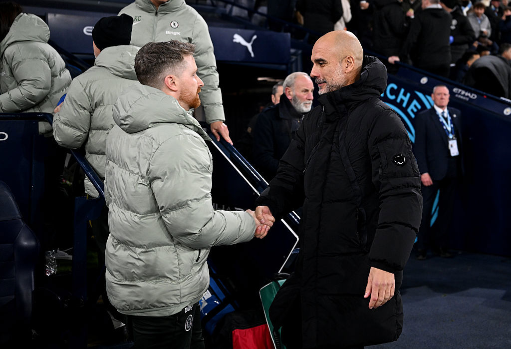 (L-R) Calum McFarlane shakes hands with Pep Guardiola. 