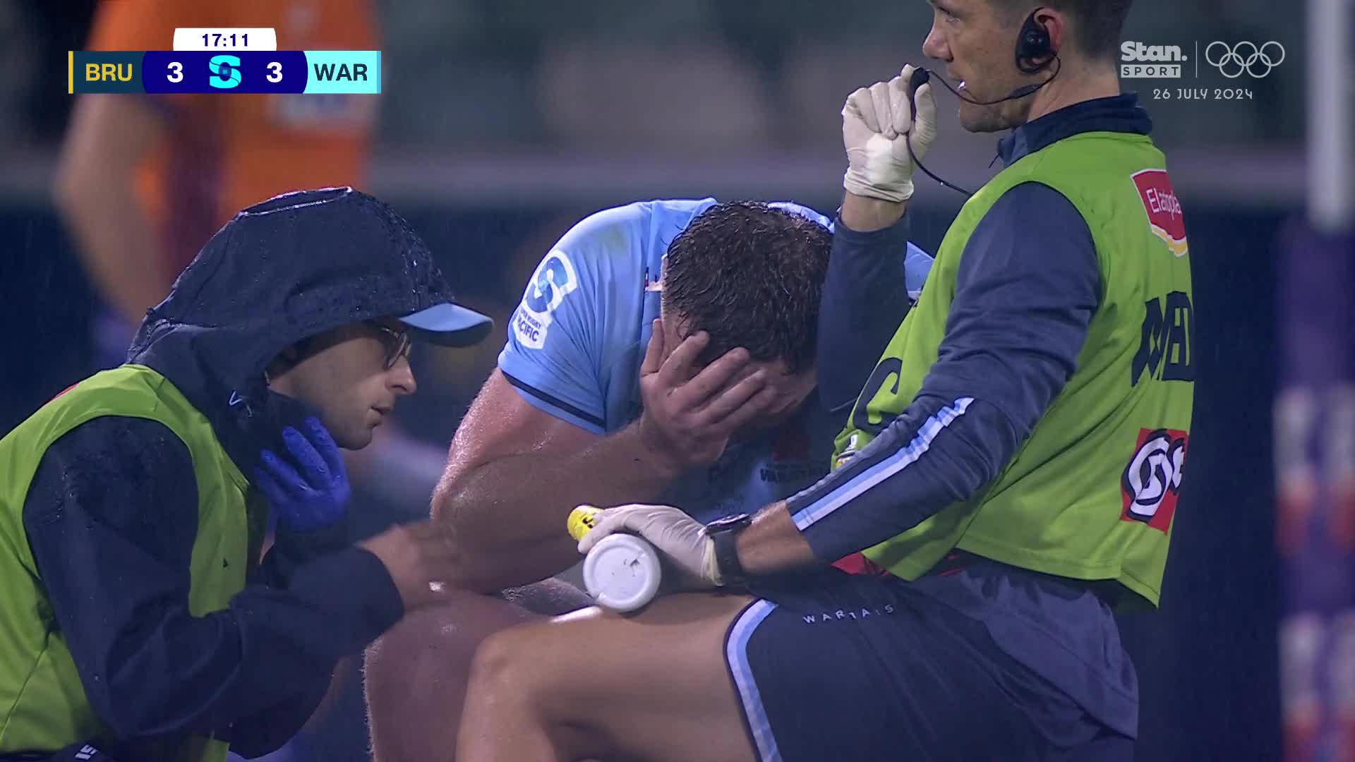 Angus Bell with head in hand after suffering a foot injury.