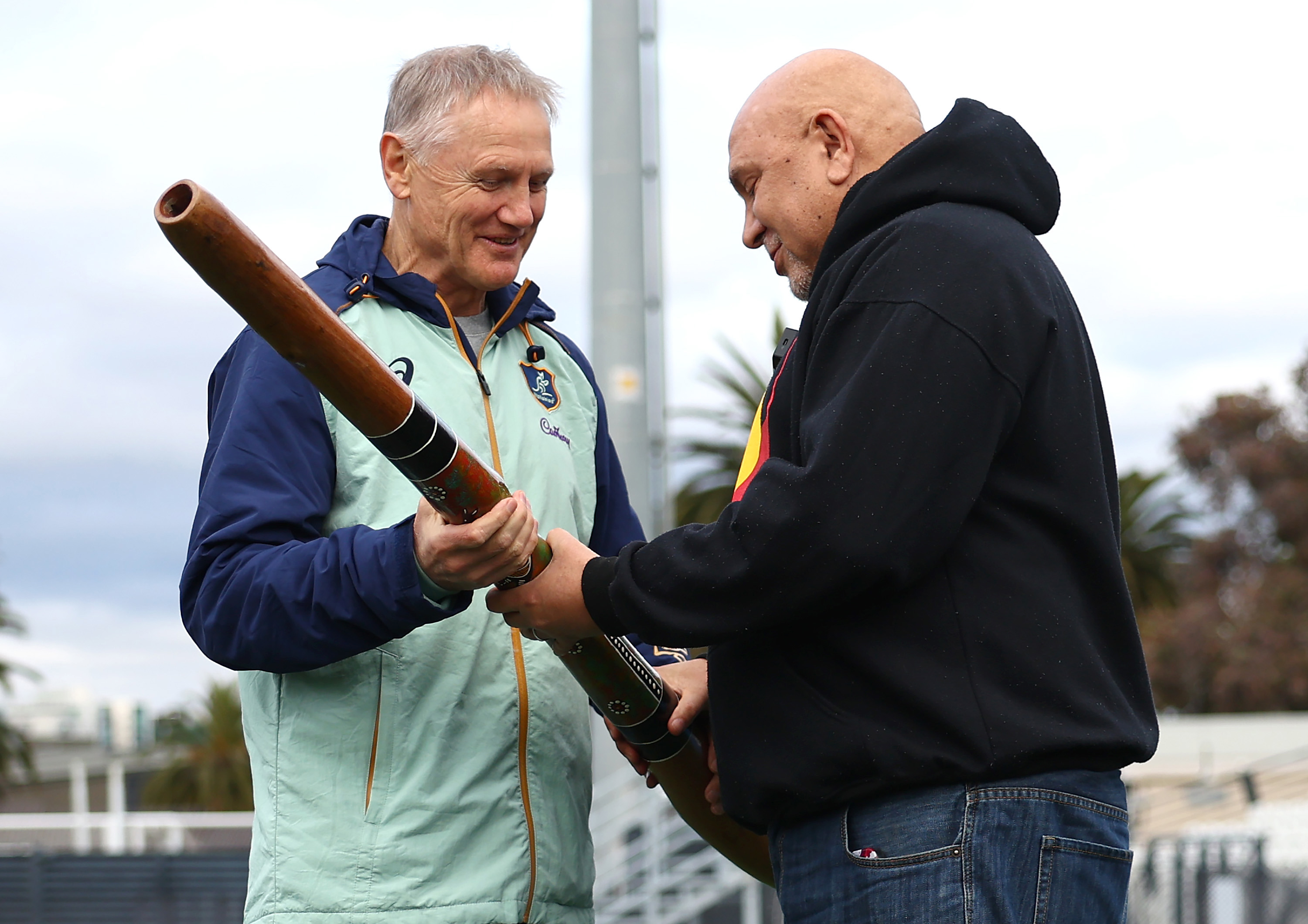 Wallabies coach Joe Schmidt is presented with a didgeridoo by First Nations advisor Dean Duncan.