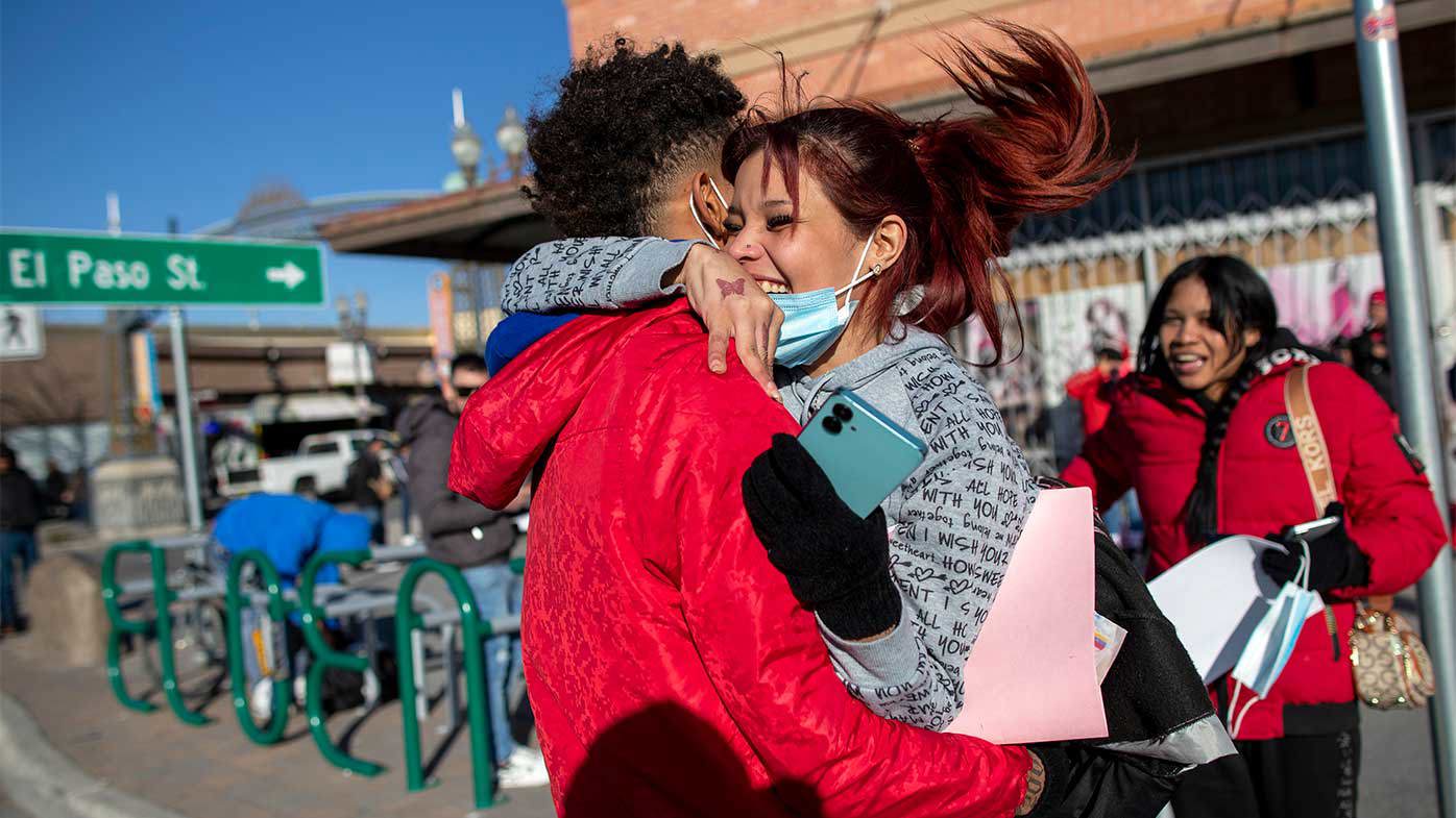 Venezuelan migrants Daniela Medina and Oldris Rodriguez hug in celebration after crossing the border into the US the day before Donald Trump took office.