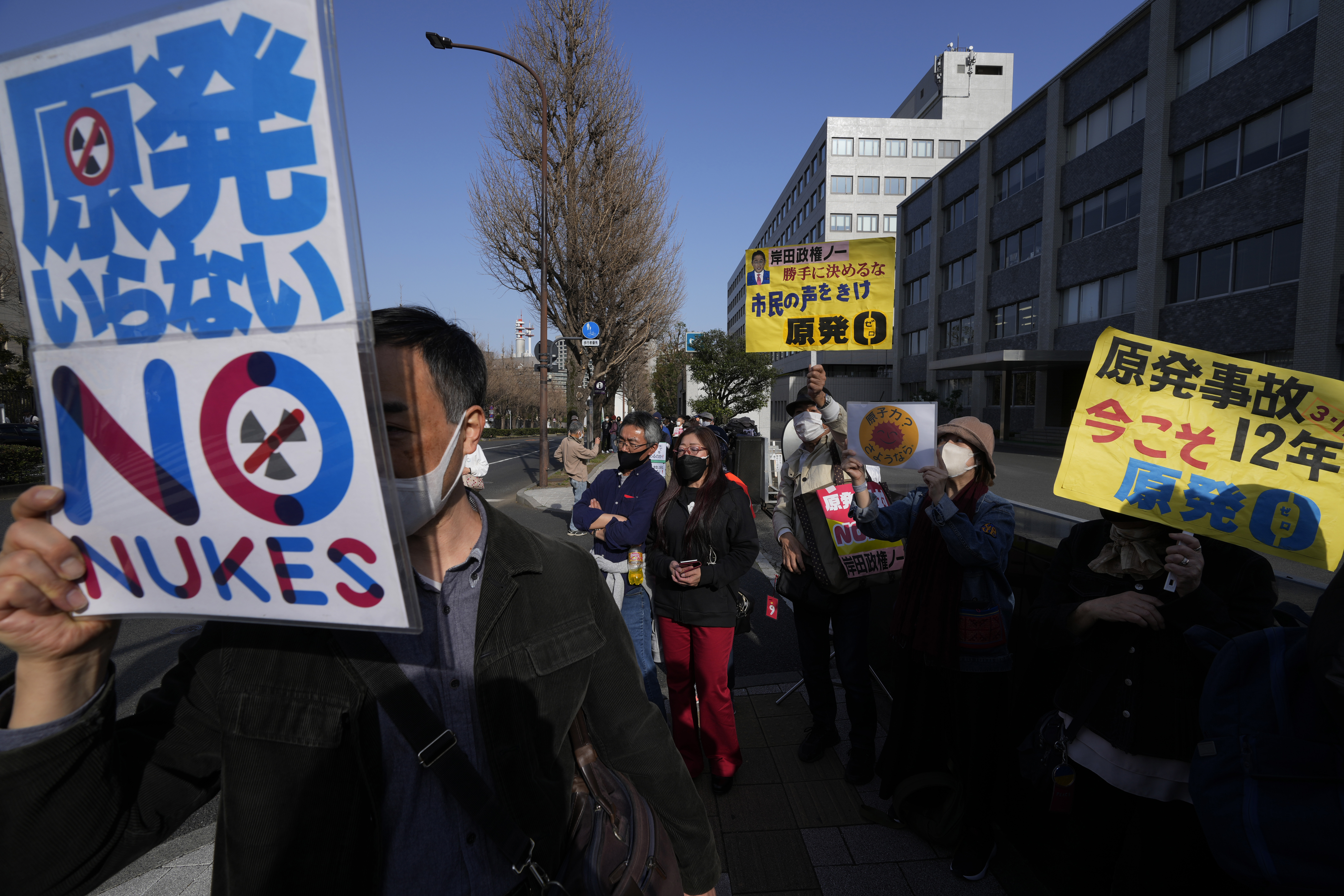 People chant slogans during a protest against the Japanese government of using the nuclear power, gathering across from the prime minister's official residence in Tokyo, Saturday, March 11, 2023, on the 12th anniversary of a disaster following a devastating earthquake and tsunami in Japan's Tohoku region.