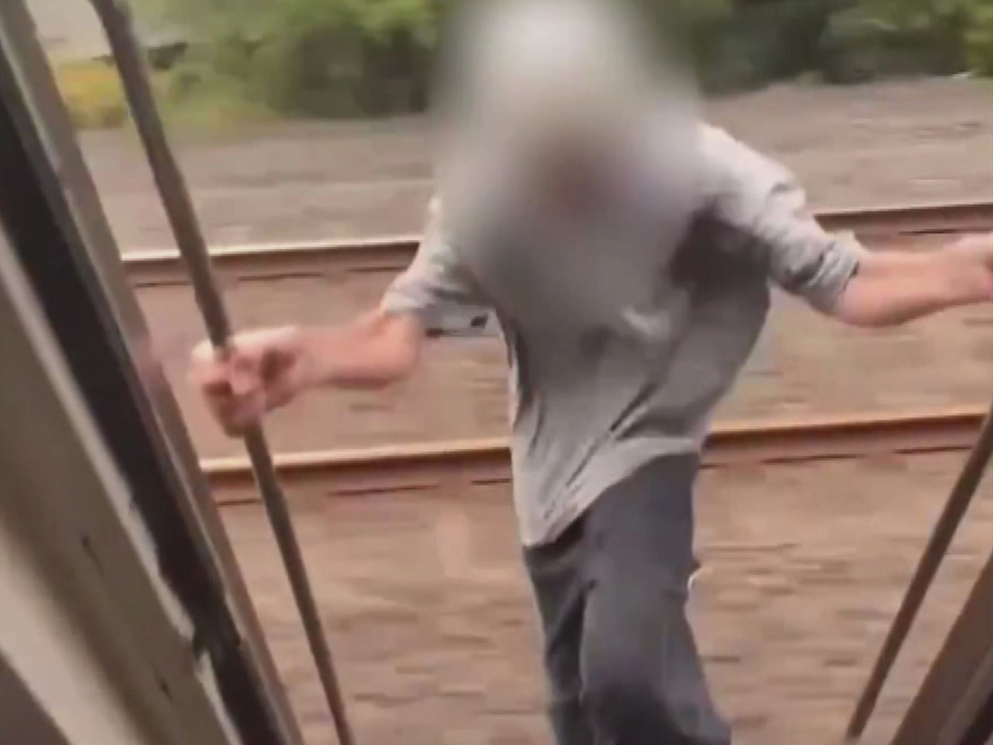 Unknown teenager hands from train in dangerous social media trend 