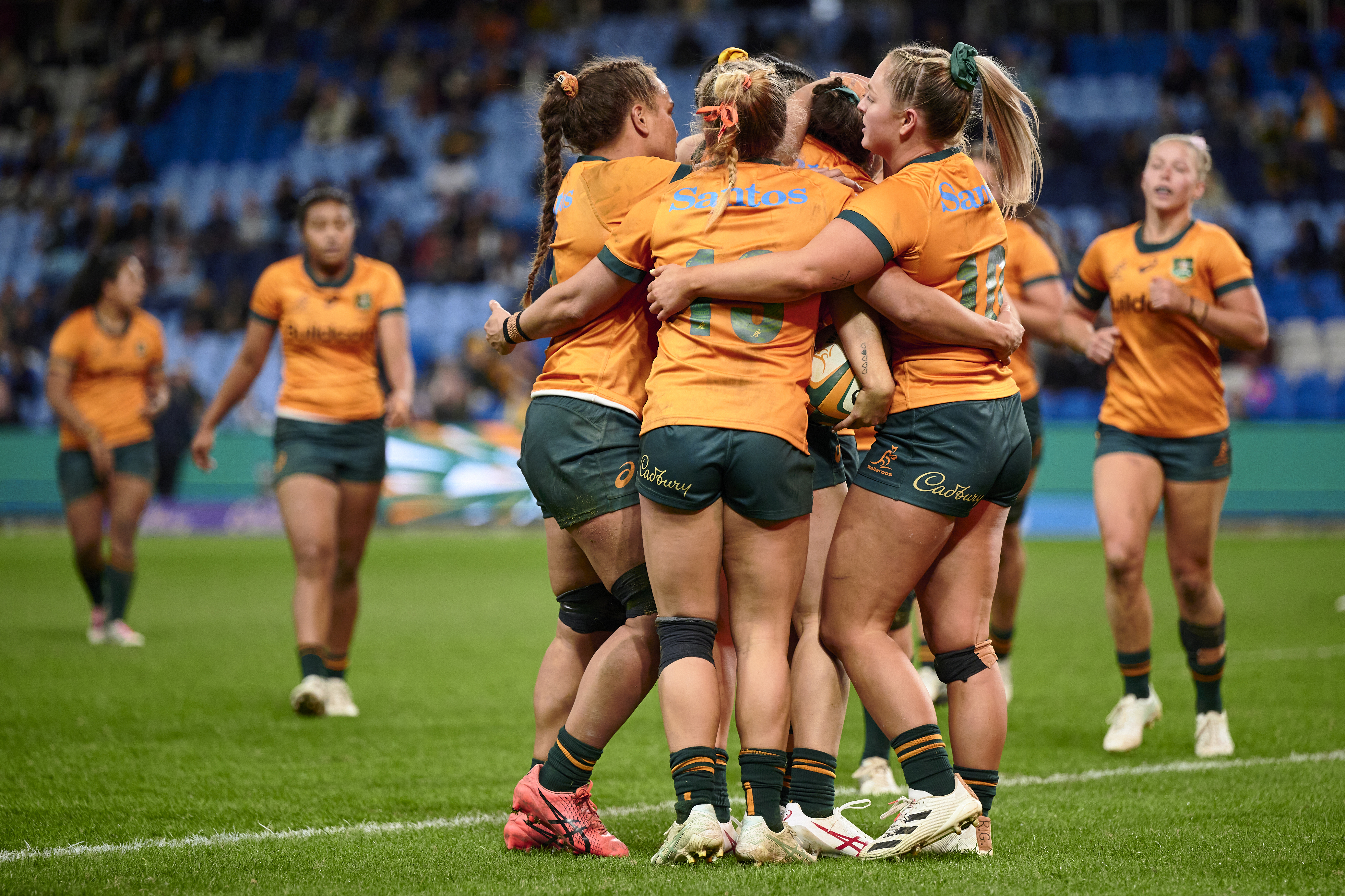 The Wallaroos celebrate after Maya Stewart scores.