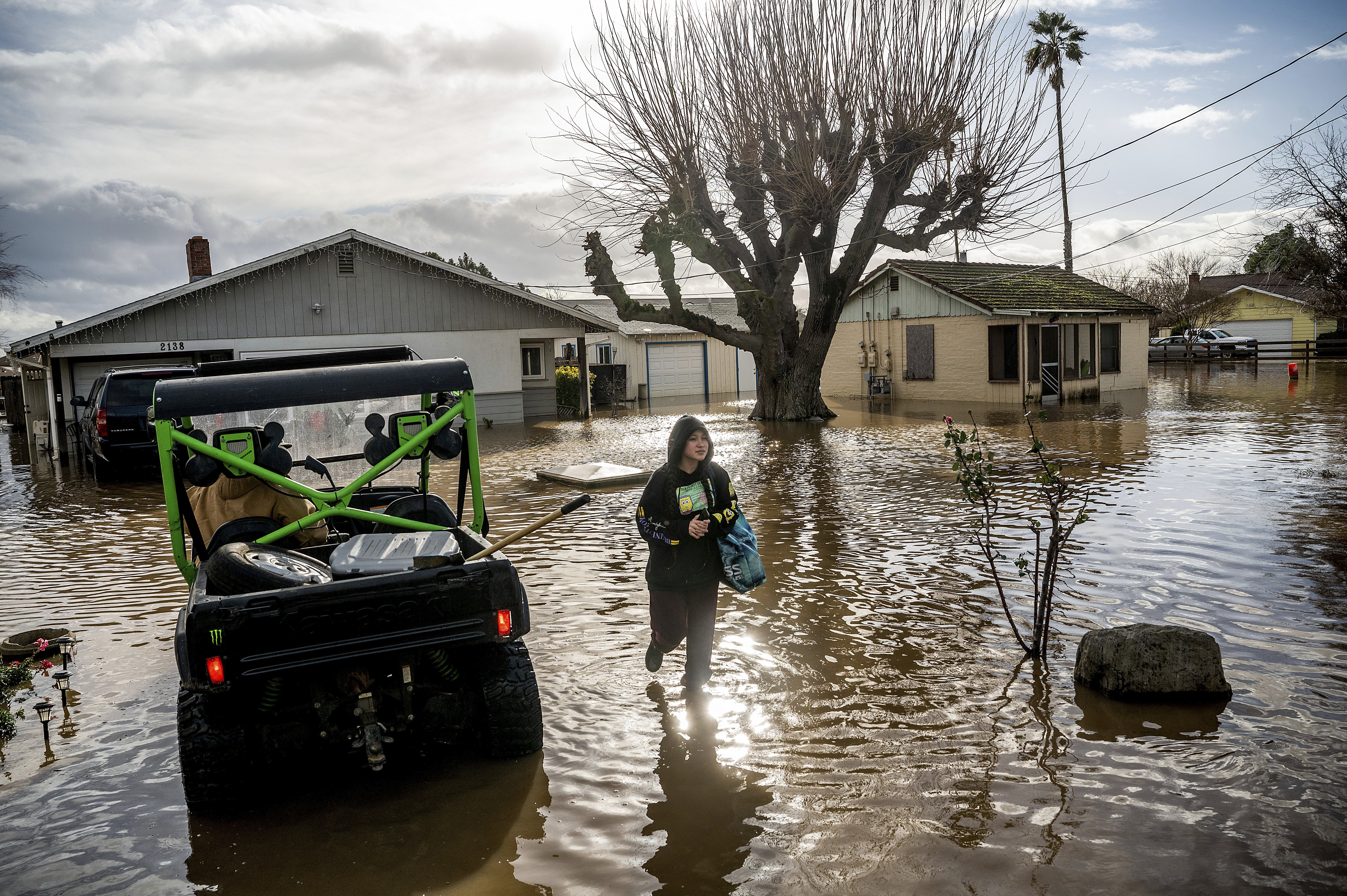 Brenda Ortega, 15, salvages items from her flooded Merced, Calif., home on Tuesday, Jan. 10, 2023.  