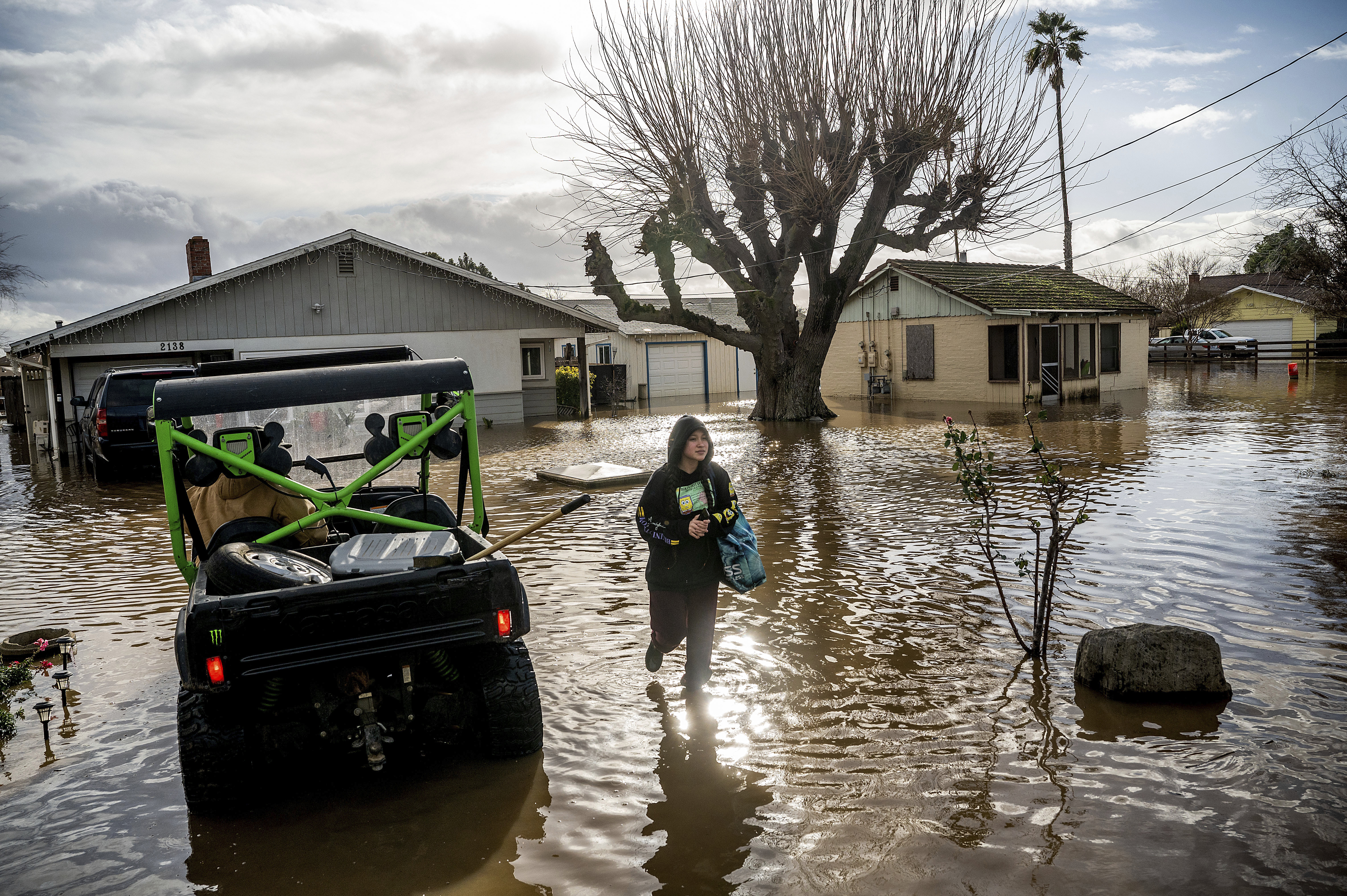 Brenda Ortega, 15, salvages items from her flooded Merced, Calif., home on Tuesday, Jan. 10, 2023.
