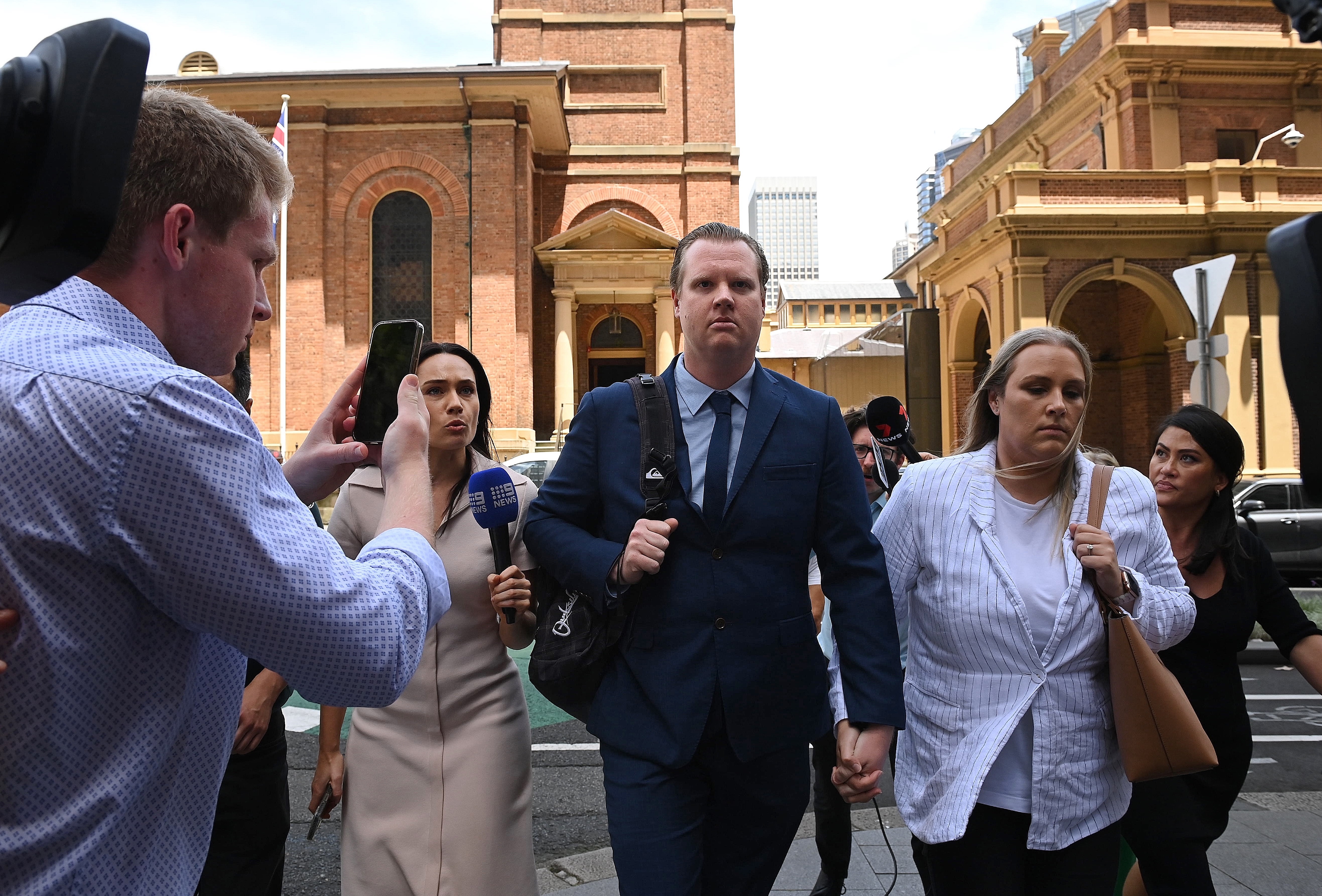 Senior Constable Kristian White (centre) leaves the NSW Supreme Court in Sydney with his fiancé (2nd from right) after he was found guilty by a jury of the manslaughter of 95 year old Clare Nowland who he tasered in a Cooma nursing home. Sydney, NSW. November 27, 2024. Photo: Kate Geraghty