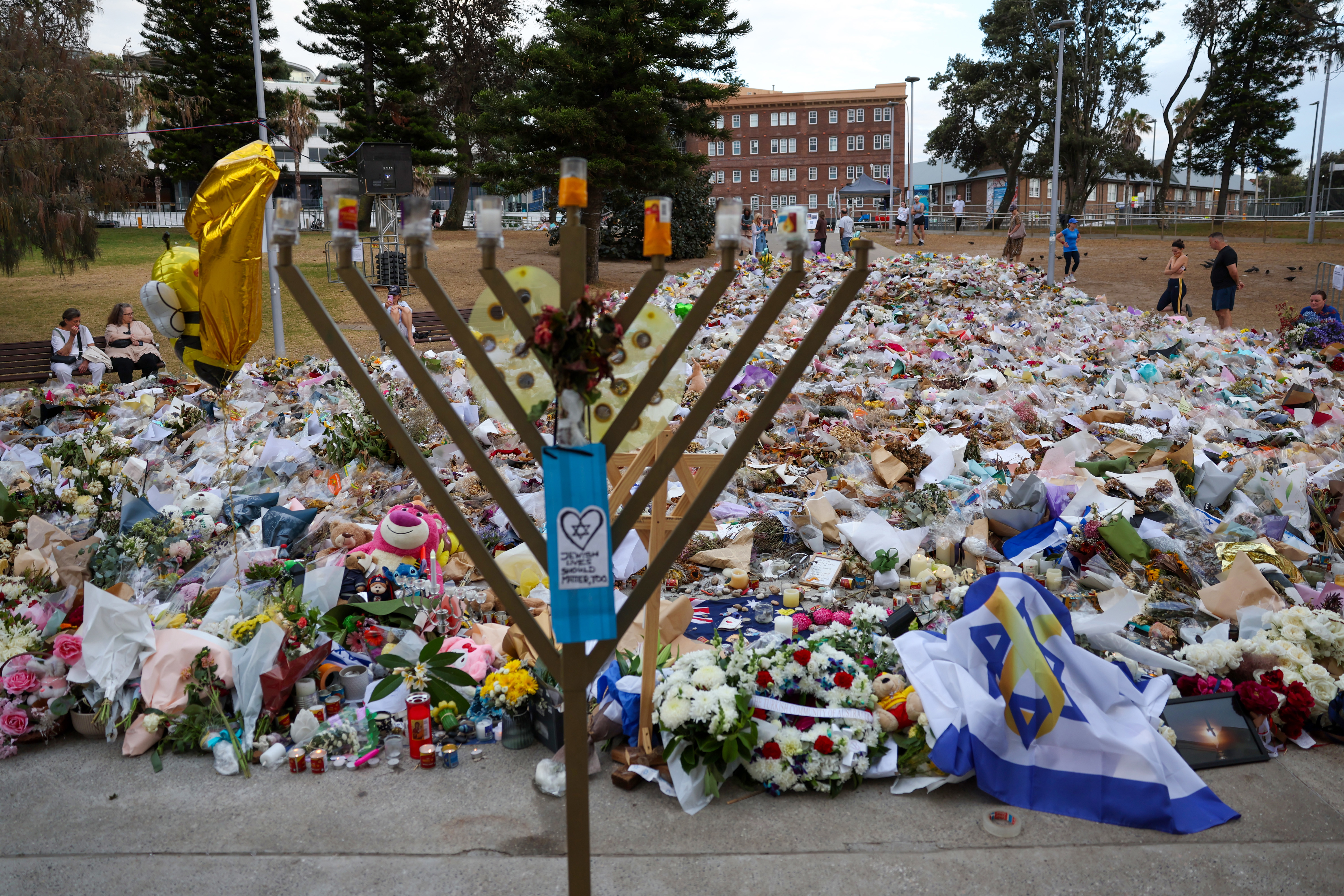 SYDNEY, AUSTRALIA - DECEMBER 21: General view of the memorial at Bondi Pavilion on December 21, 2025 in Sydney, Australia. Life slowly returned to normal at Bondi Beach, with people from all walks of life still paying respects and tributes as raw grief and funerals gave way to quiet commemorations. Police say at least 16 people, including one suspected gunman, were killed and more than 40 others injured when two attackers opened fire near a Hanukkah celebration at the world-famous Bondi Beach, i