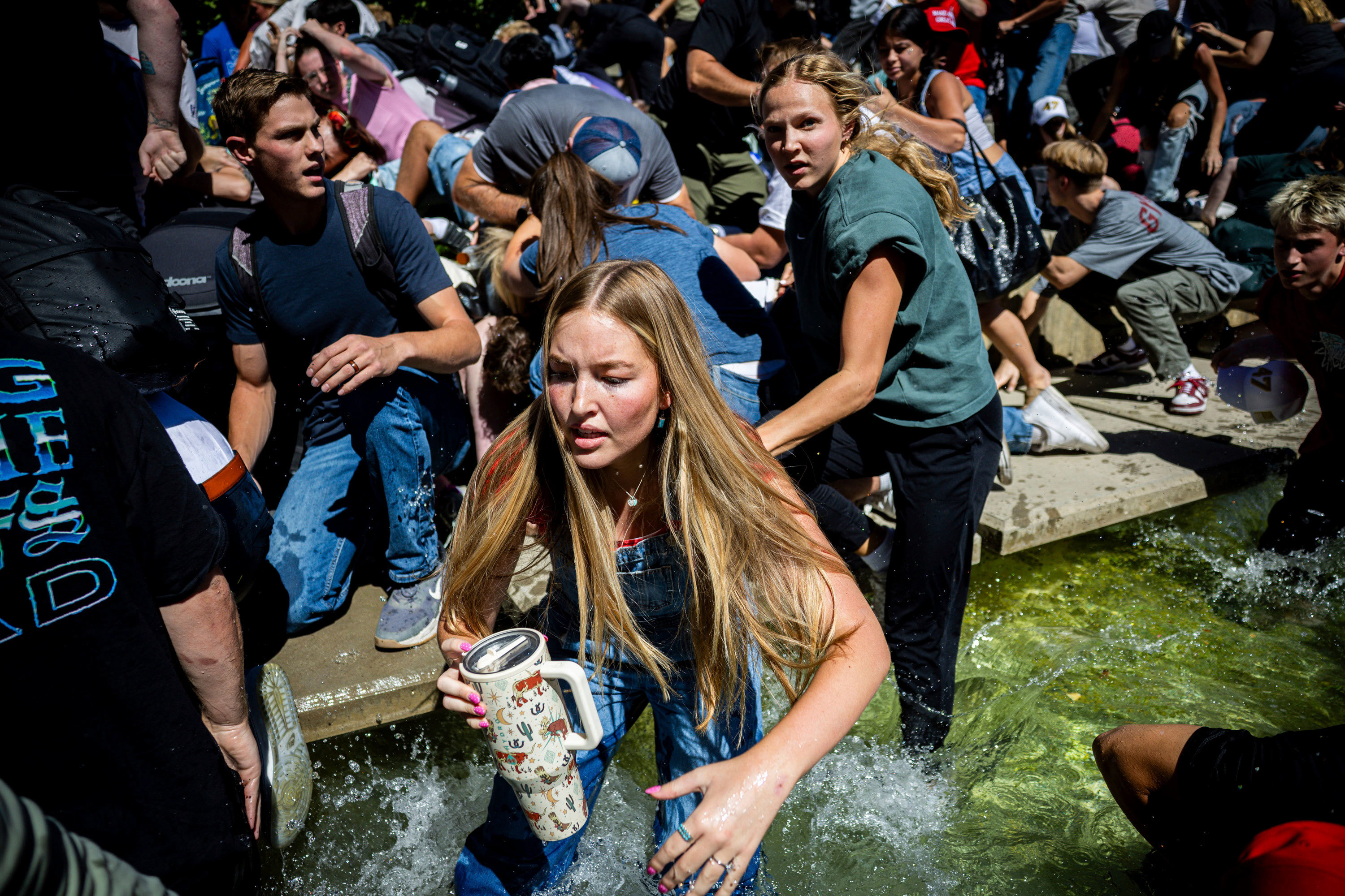 The crowd reacts in fear and shock after Charlie Kirk is shot.