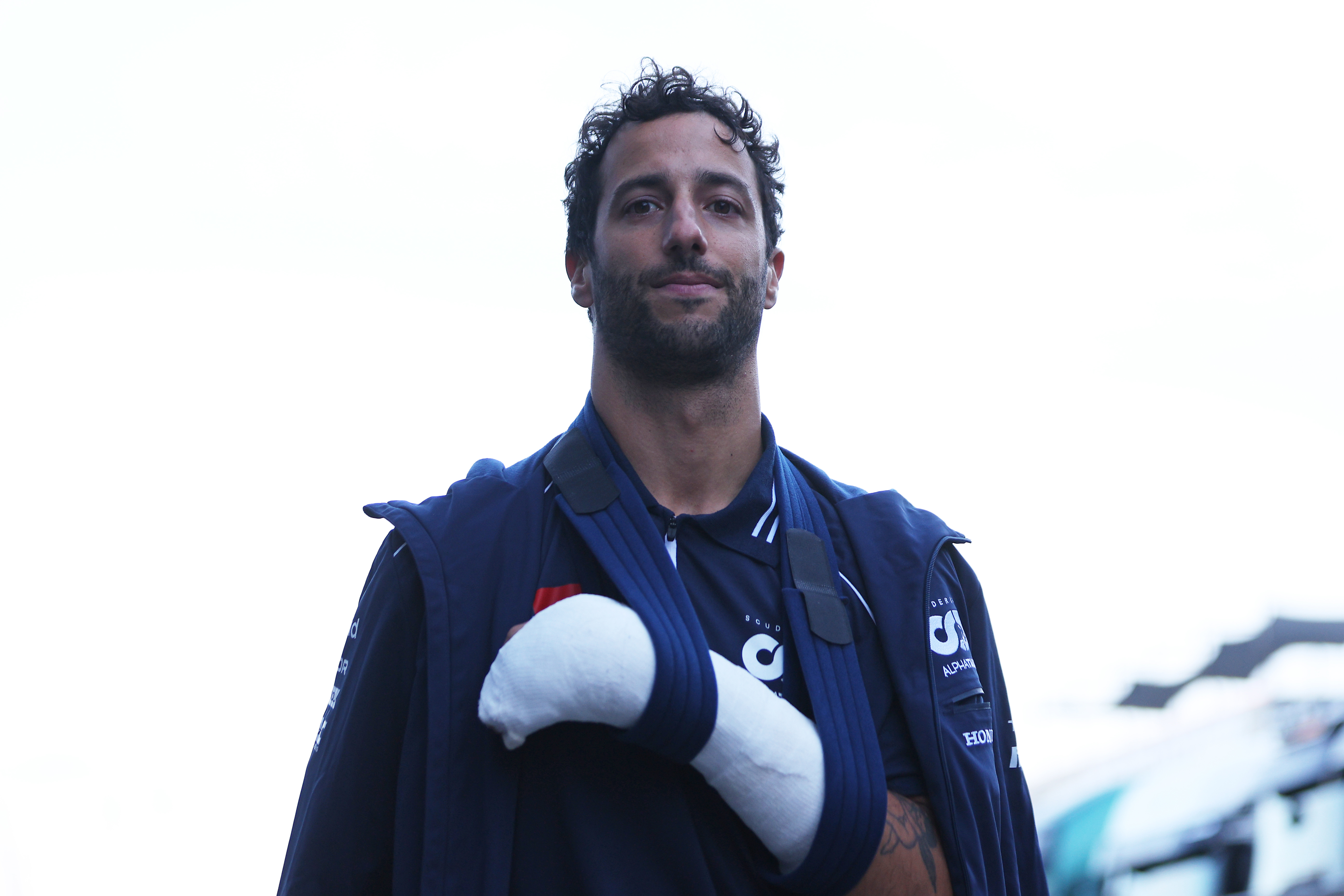 Daniel Ricciardo of Australia and Scuderia AlphaTauri wears a cast on his hand after crashing during practice which has ruled him out of competing in this weekends race ahead of the F1 Grand Prix of The Netherlands at Circuit Zandvoort on August 25, 2023 in Zandvoort, Netherlands. (Photo by Dean Mouhtaropoulos/Getty Images)