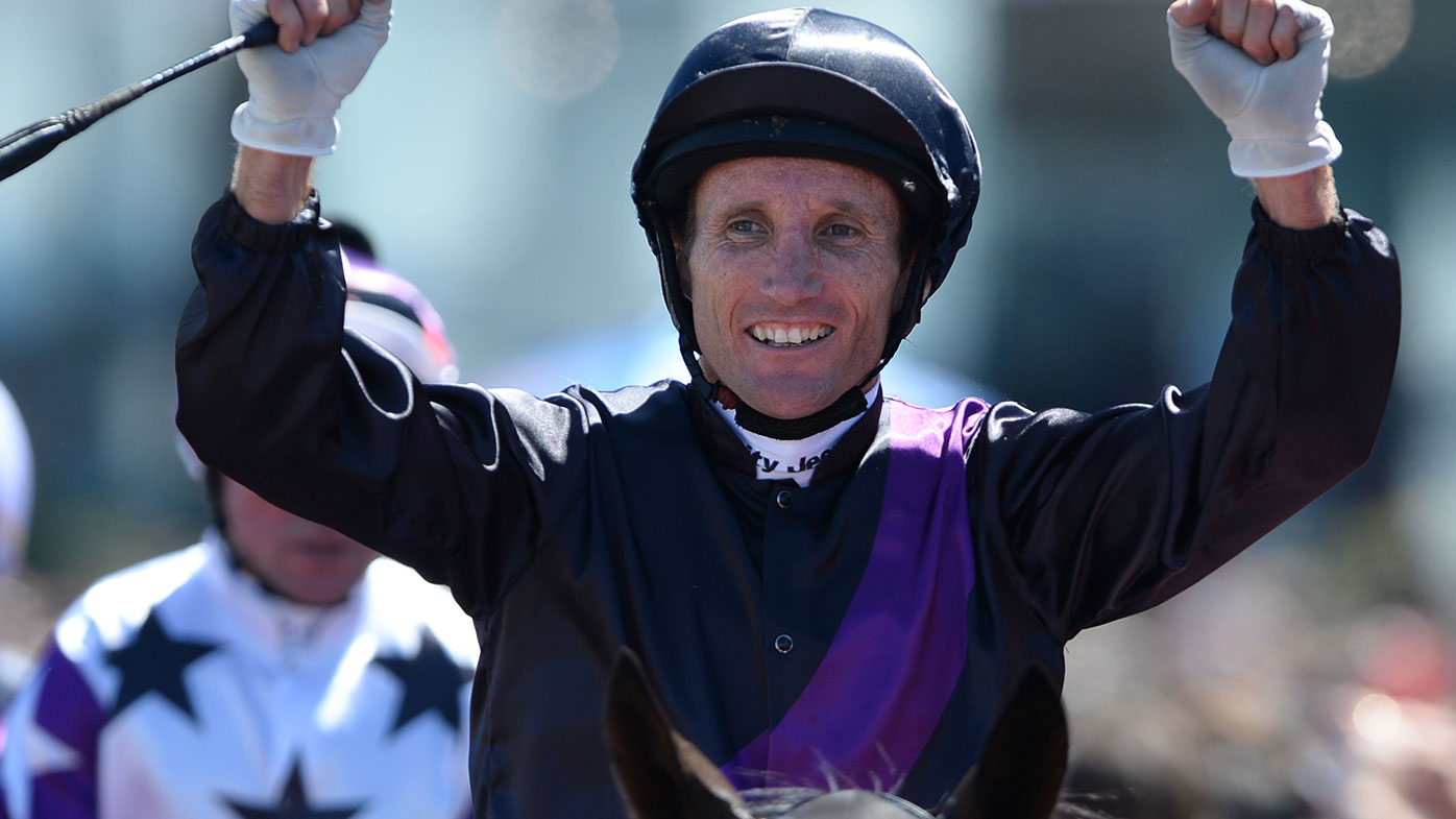 Damien Oliver celebrates after winning the 2013 Melbourne Cup on Fiorente.