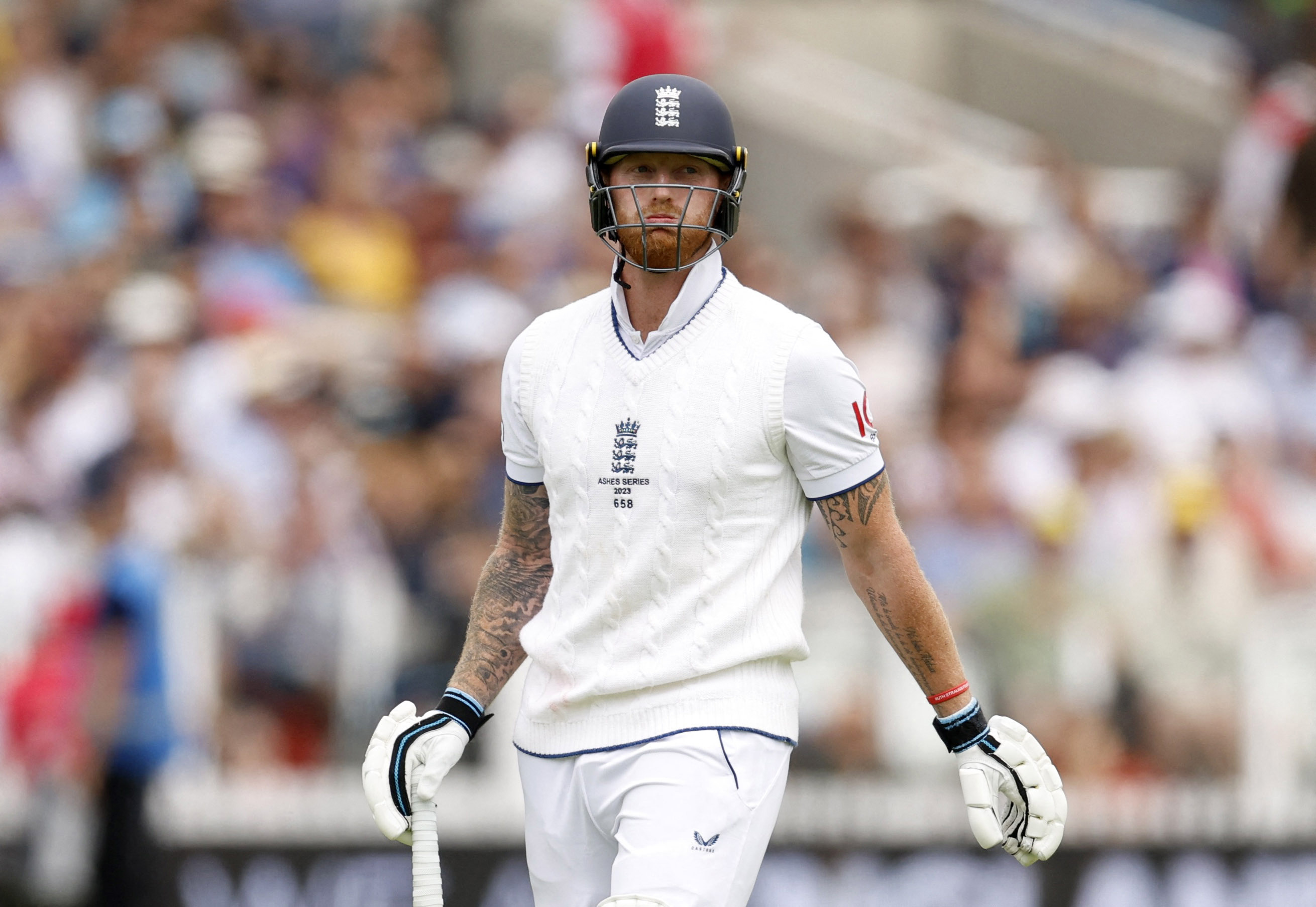 England's Ben Stokes walks after losing his wicket, caught by Australia's Cameron Green off the bowling of Mitchell Starc.