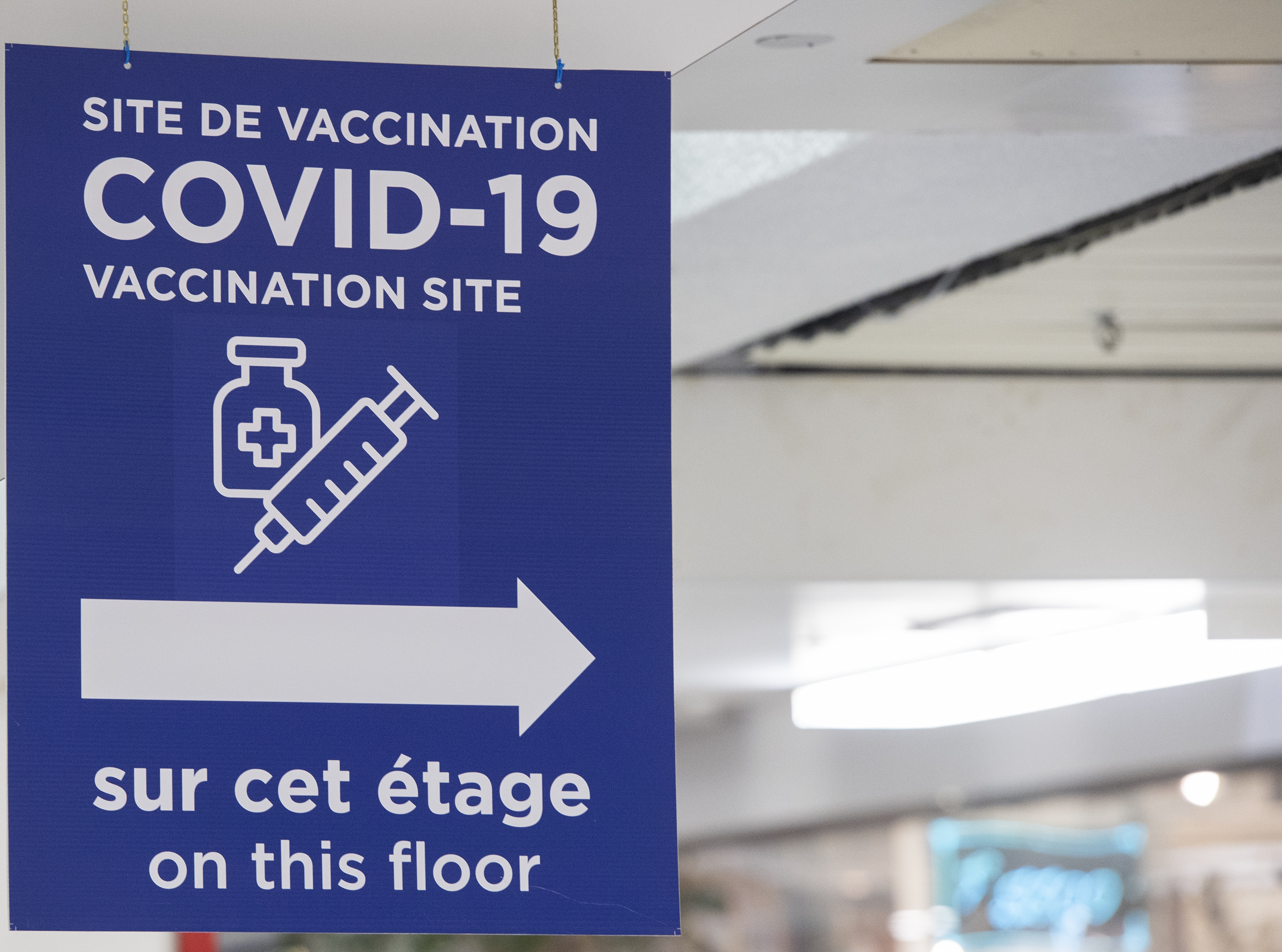 Signage at the Decarie Square Covid-19 vaccination site in Montreal, Quebec, Canada, on Wednesday, Jan. 12, 2022. Members of the armed services have been deployed in the province since January 3 to help with third dose vaccination efforts as hospitalizations rise. Photographer: Graham Hughes/Bloomberg
