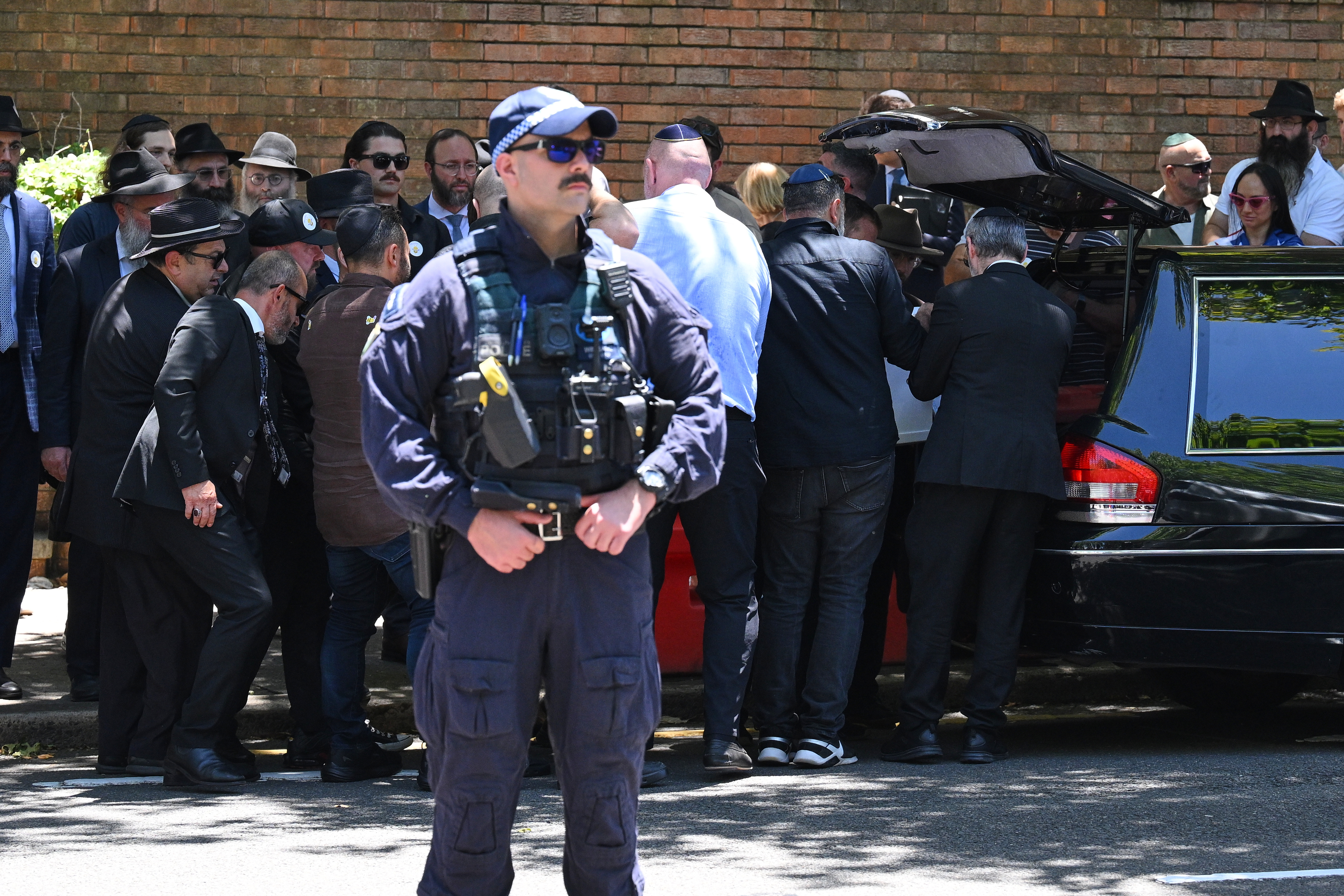 Family place the coffin into a hearse following a service for Bondi Beach mass shooting victim 10-year-old Matilda, whose last name is being withheld at the request of her family, in Sydney, Thursday, Dec. 18, 2025. (AP Photo/Steve Markham)