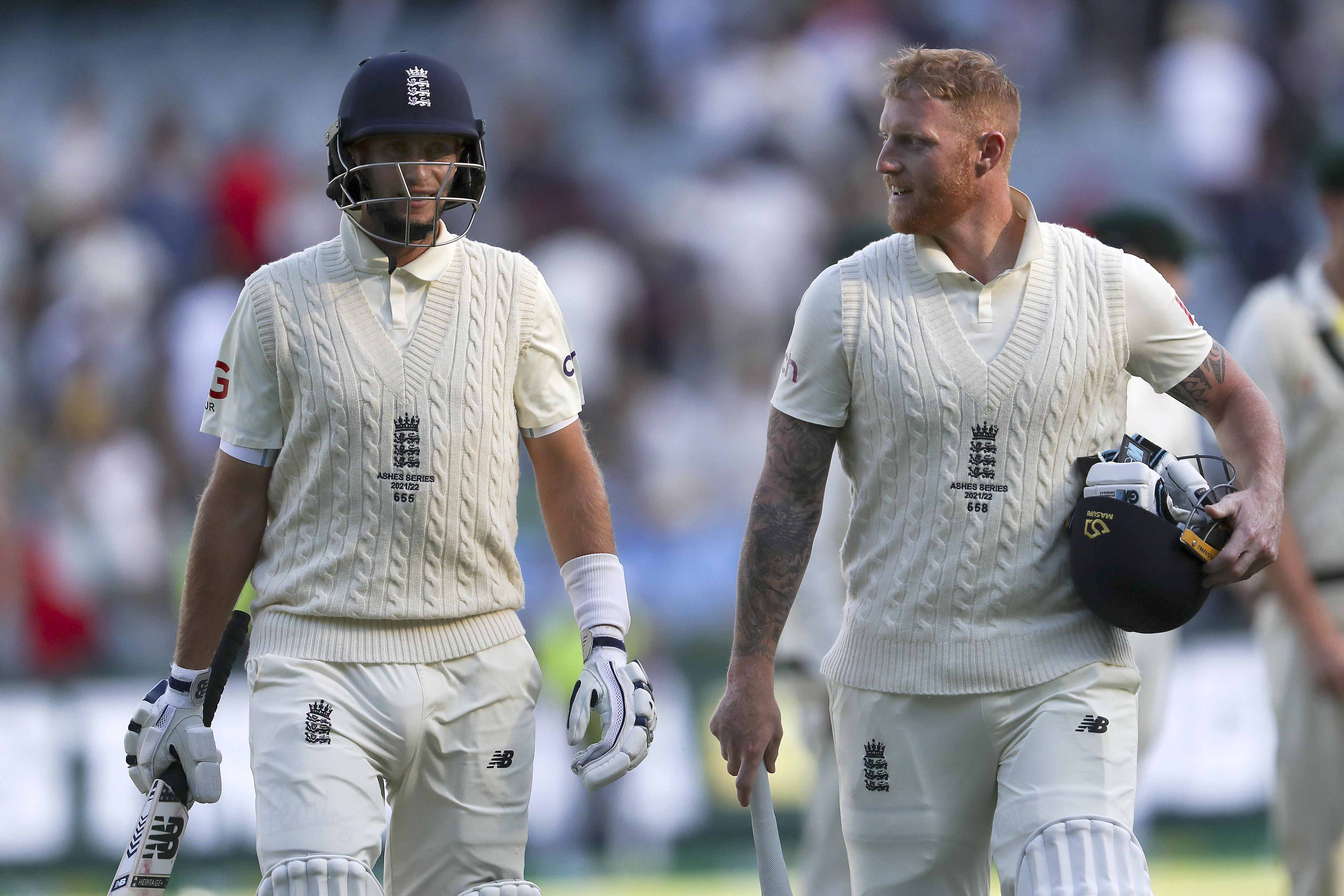 Joe Root and Ben Stokes leave the field.