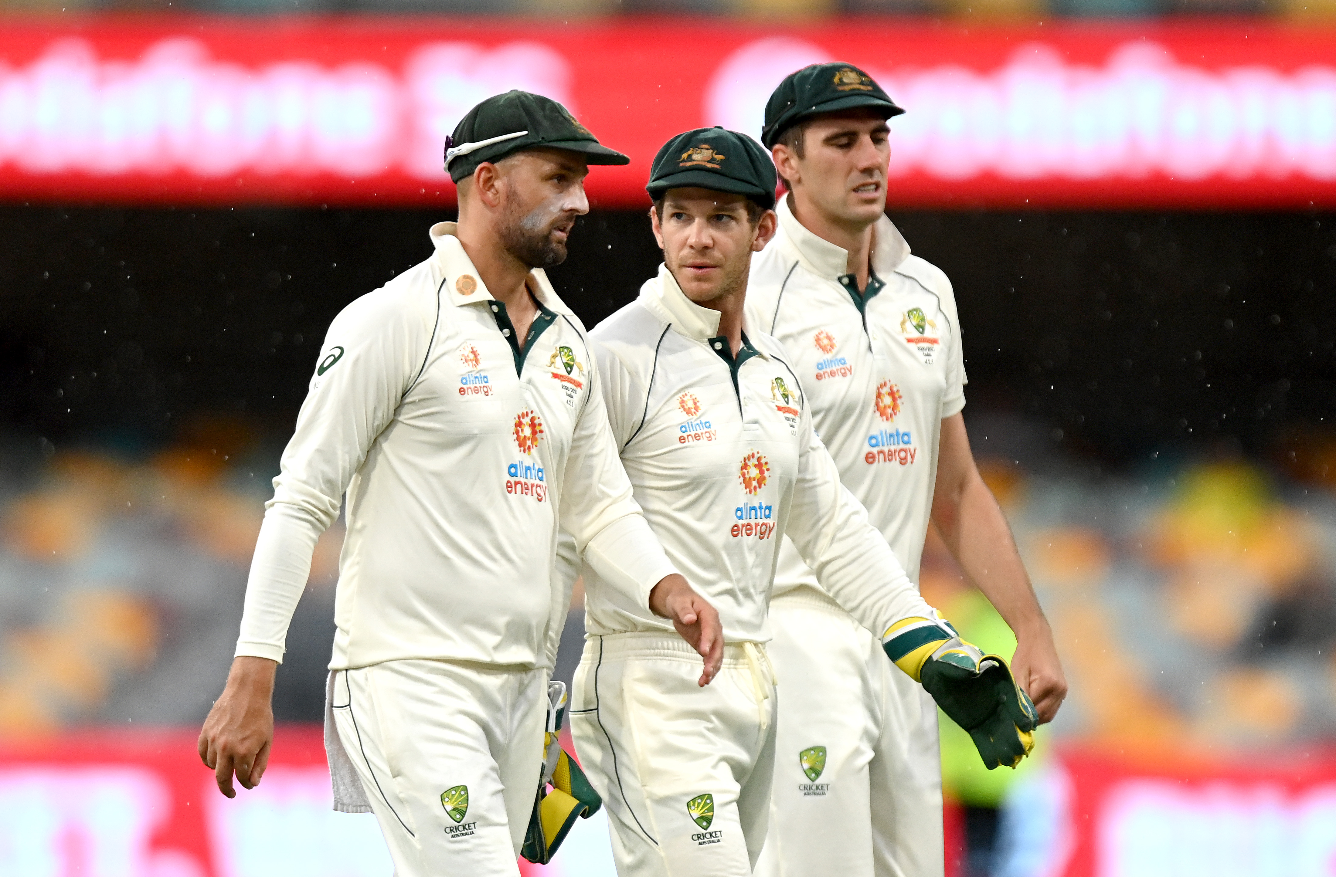 Tim Paine (centre) with Nathan Lyon and Pat Cummins of Australia.