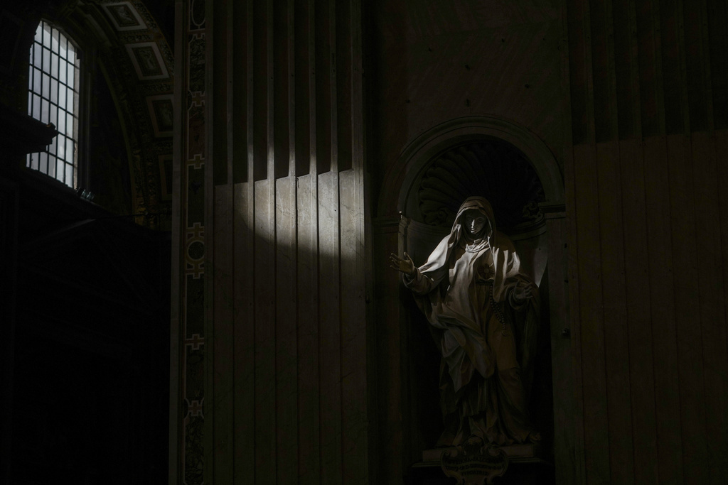 Sunlight filtering through a window illuminates the statue of Catholic Saint Giuliana Falconieri during a mass for the Jubilee of Deacons in St. Peter's Basilica at The Vatican, Sunday, Feb. 23, 2025, that was supposed to be presided over by Pope Francis who was admitted over a week ago at Rome's Agostino Gemelli Polyclinic and is in critical condition. (AP Photo/Alessandra Tarantino)