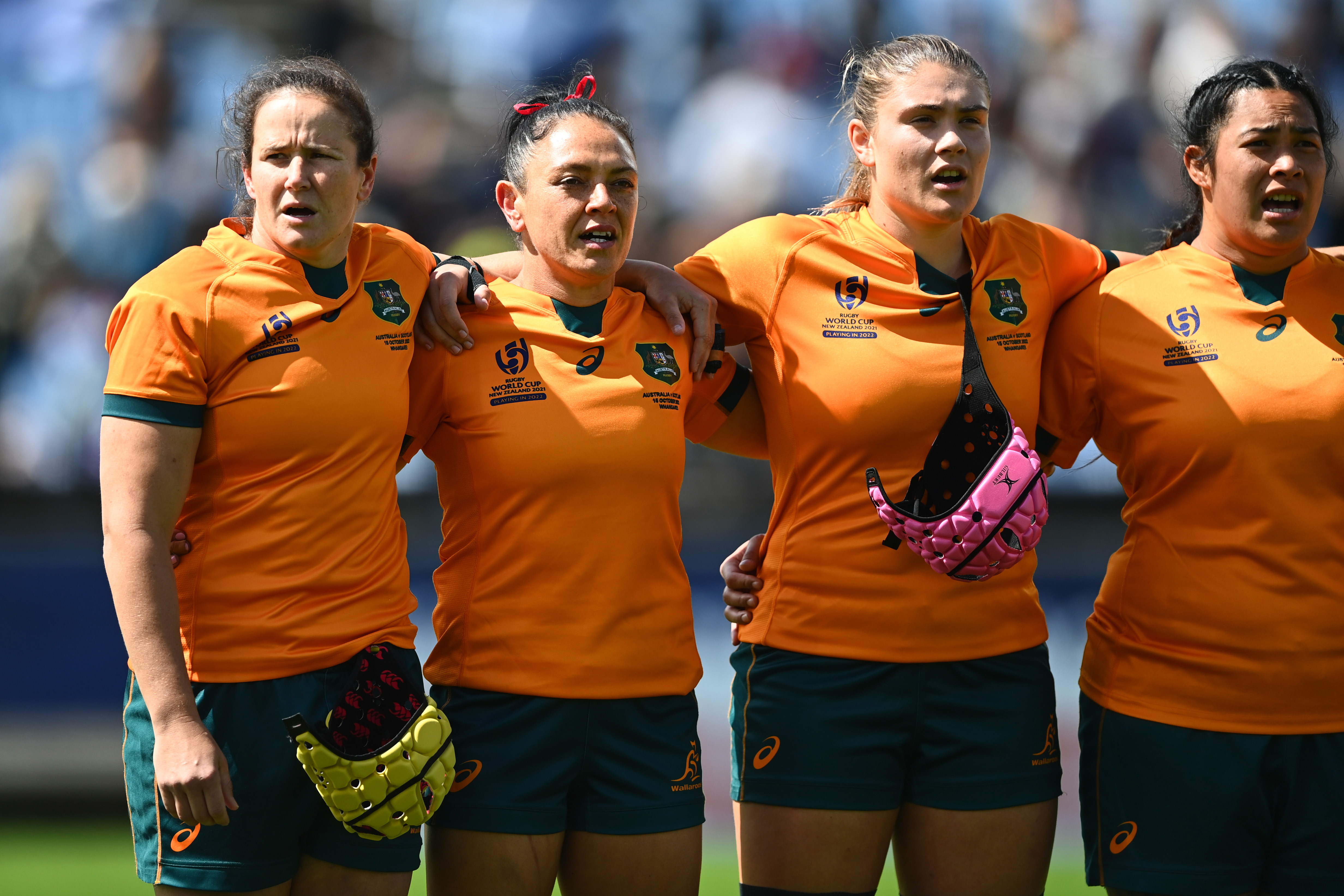 Shannon Parry (left), Iliseva Batibasaga, and incoming captain Piper Duck (right) sing the national anthem.