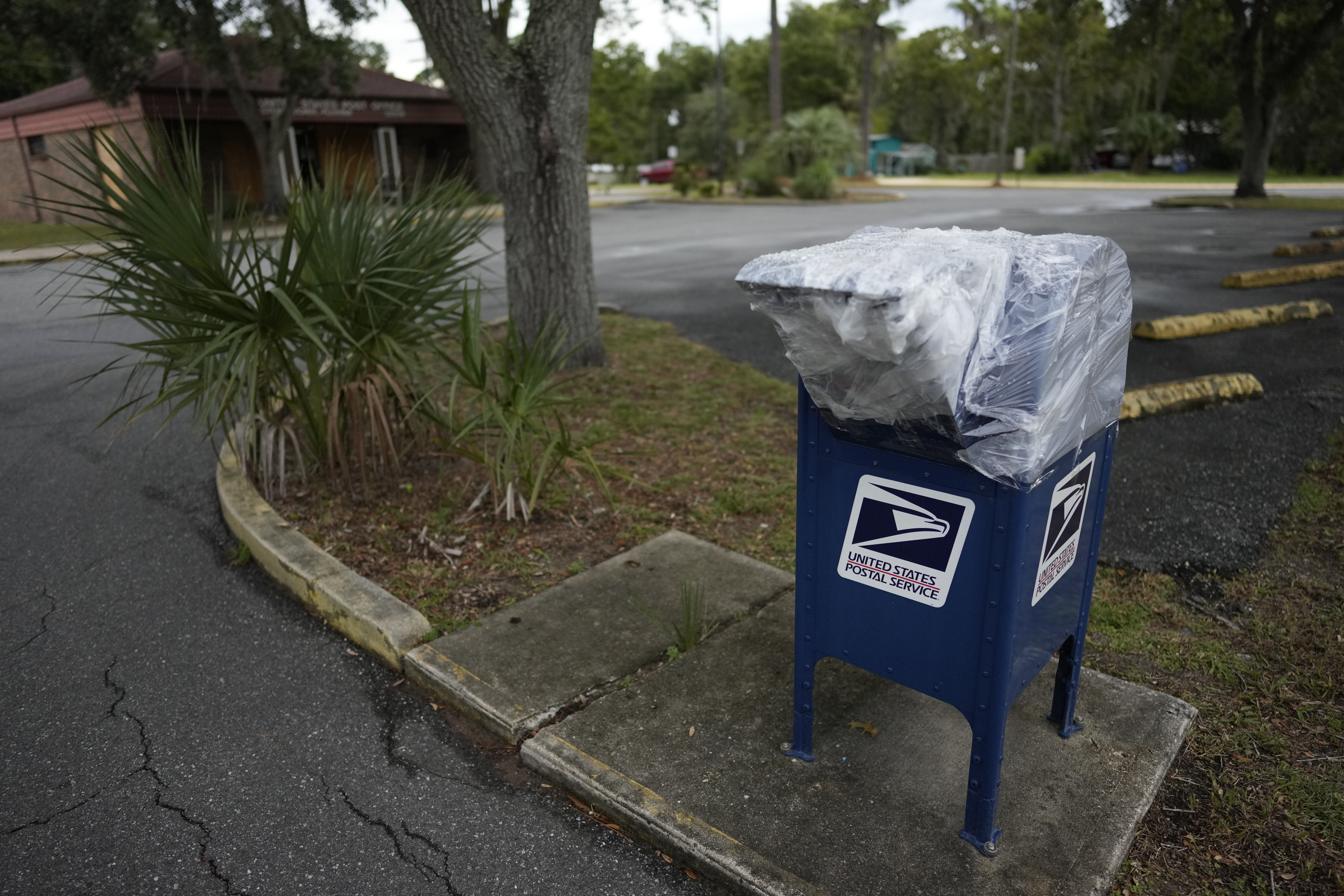 Plastic wrap closes off a mailbox outside the Steinhatchee, Fla. post office, ahead of the expected arrival of Hurricane Idalia, Tuesday, Aug. 29, 2023