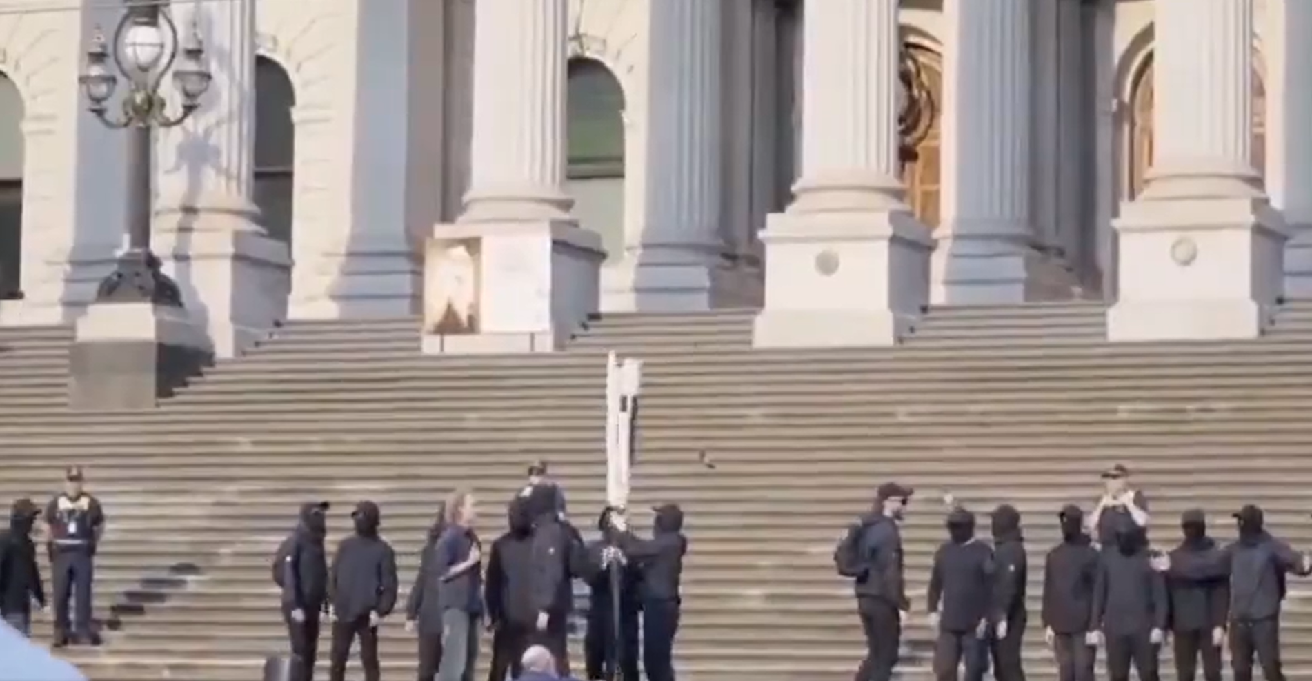 Police are seeking to identify a group of neo-Nazis who posed for a photo and chanted on the steps of Victoria's Parliament House. ﻿