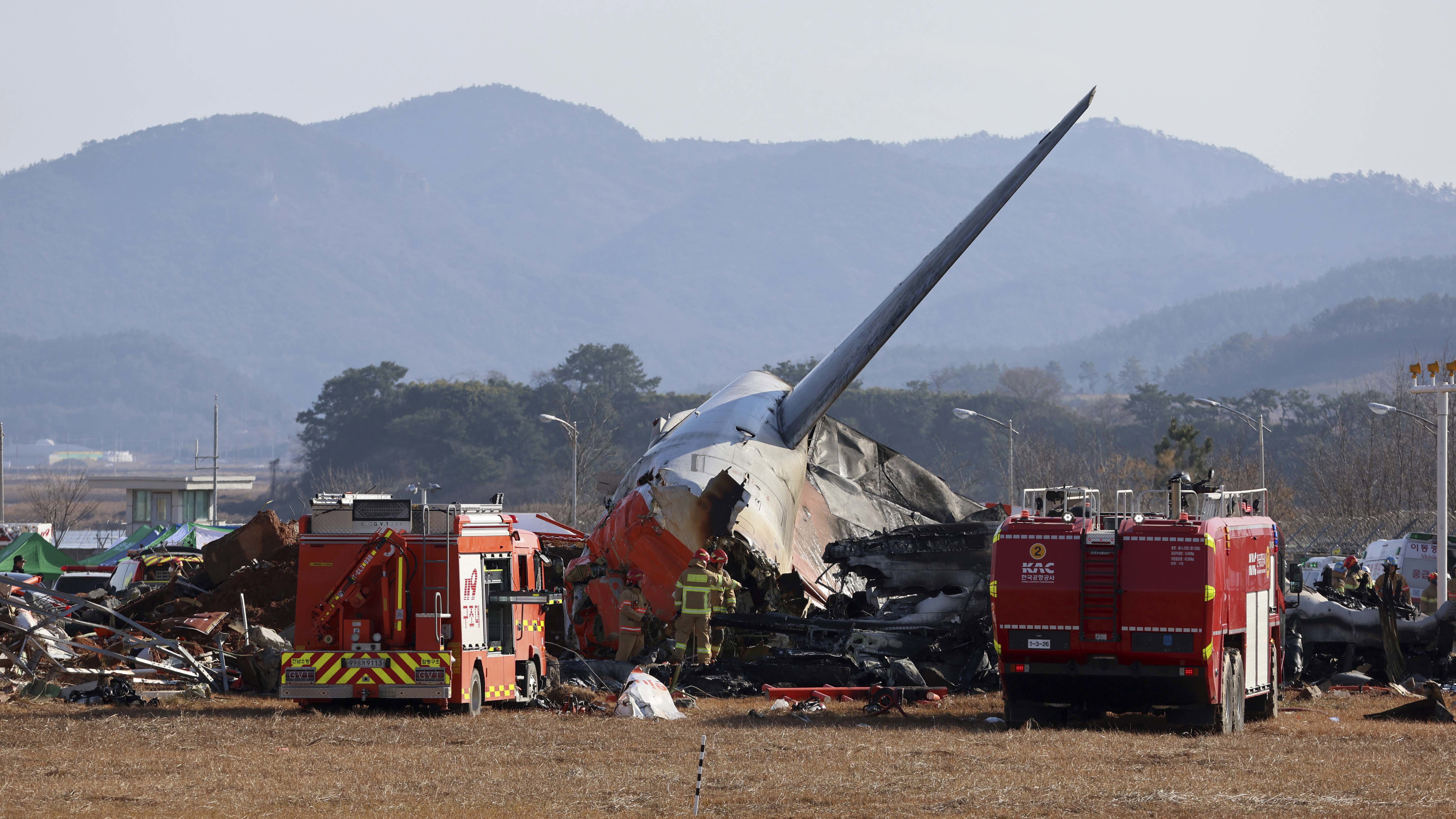 Firefighters and rescue team members work at Muan International Airport in Muan, South Korea