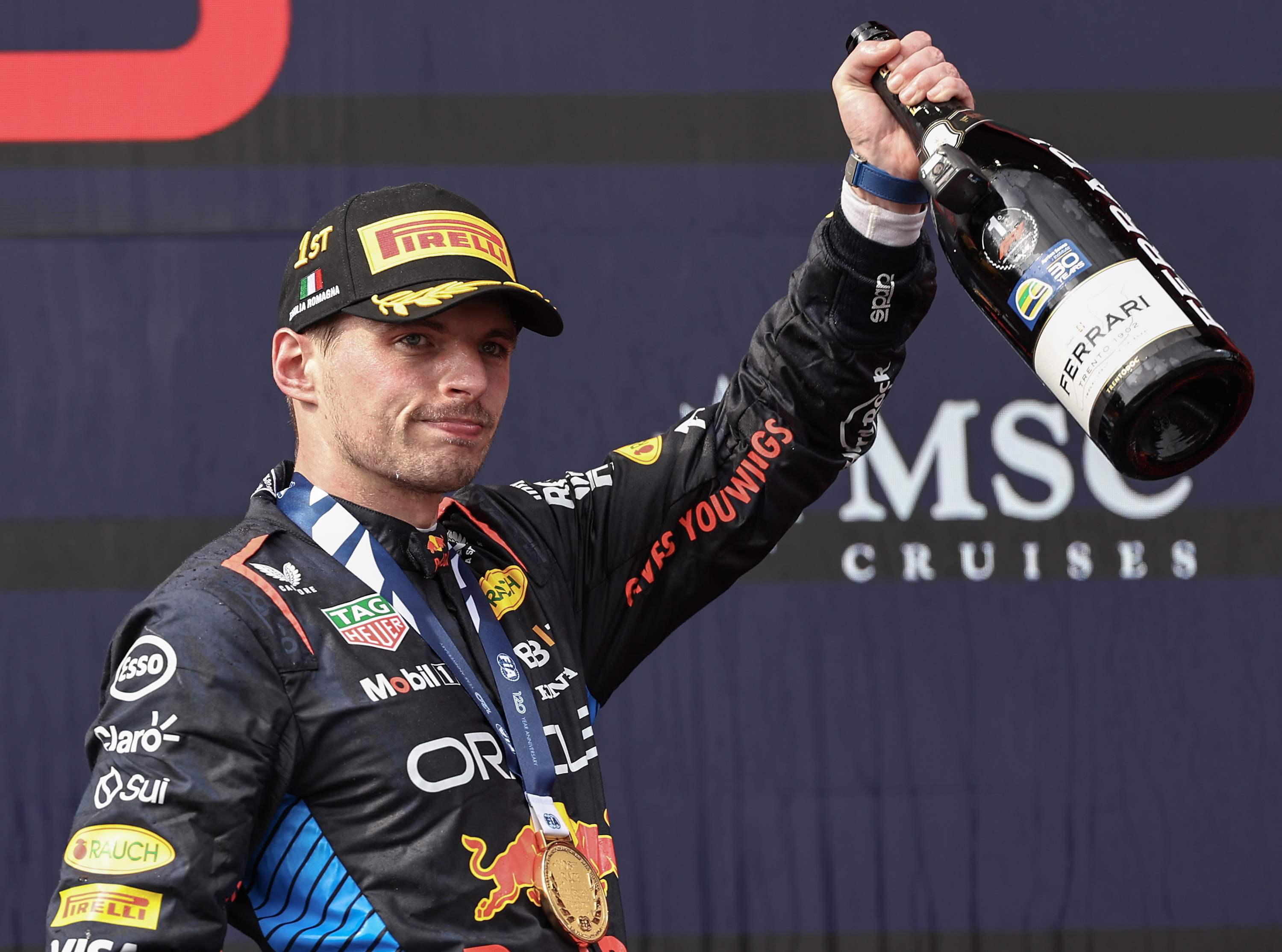 Max Verstappen of the Netherlands and Oracle Red Bull Racing celebrates his win on the podium during the F1 Grand Prix of Emilia-Romagna at Autodromo Enzo e Dino Ferrari Circuit on May 19, 2024 in Imola, Italy.(Photo by Qian Jun/MB Media/Getty Images)