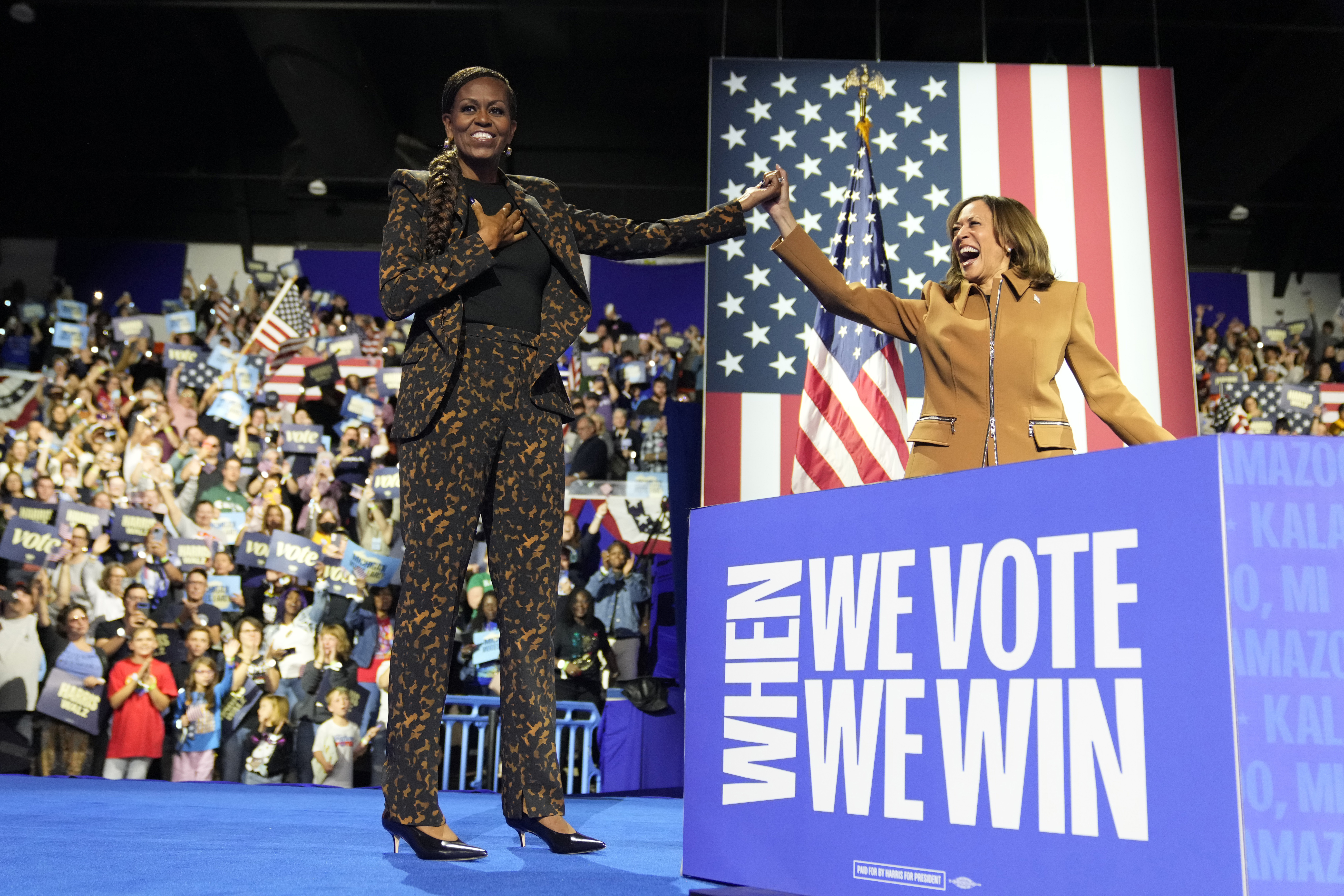 Former first lady Michelle Obama, left, and Democratic presidential nominee Vice President Kamala Harris depart after speaking at a campaign rally at the Wings Event Center in Kalamazoo, Mich. (AP Photo/Jacquelyn Martin)