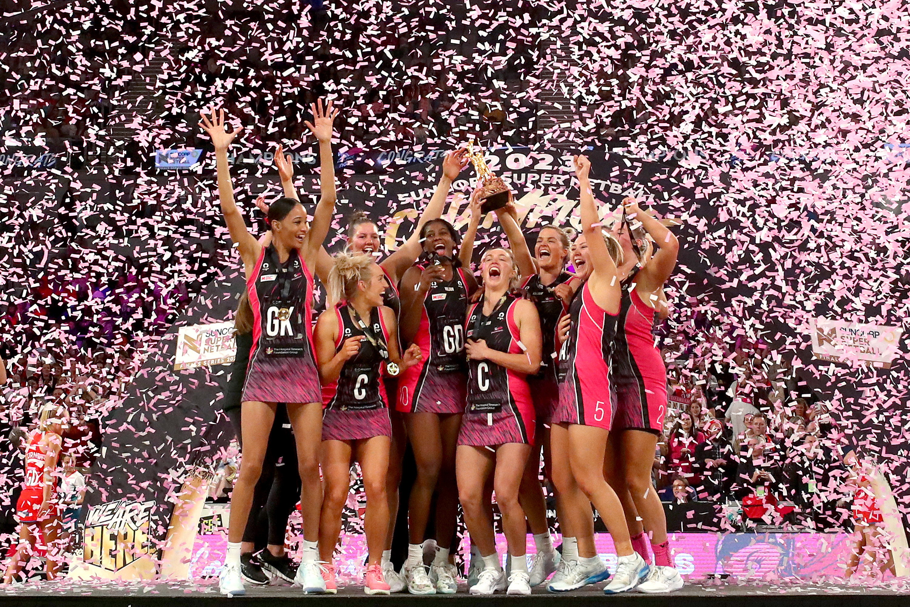 The Adelaide Thunderbirds celebrate with the trophy after winning the 2023 Super Netball grand final.