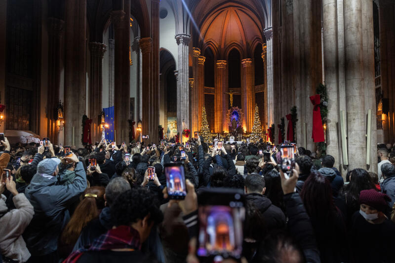 People take pictures and video as they attend a Christmas Eve mass at the Saint Anthony of Padua Church on December 24, 2025 in Istanbul, Turkey.