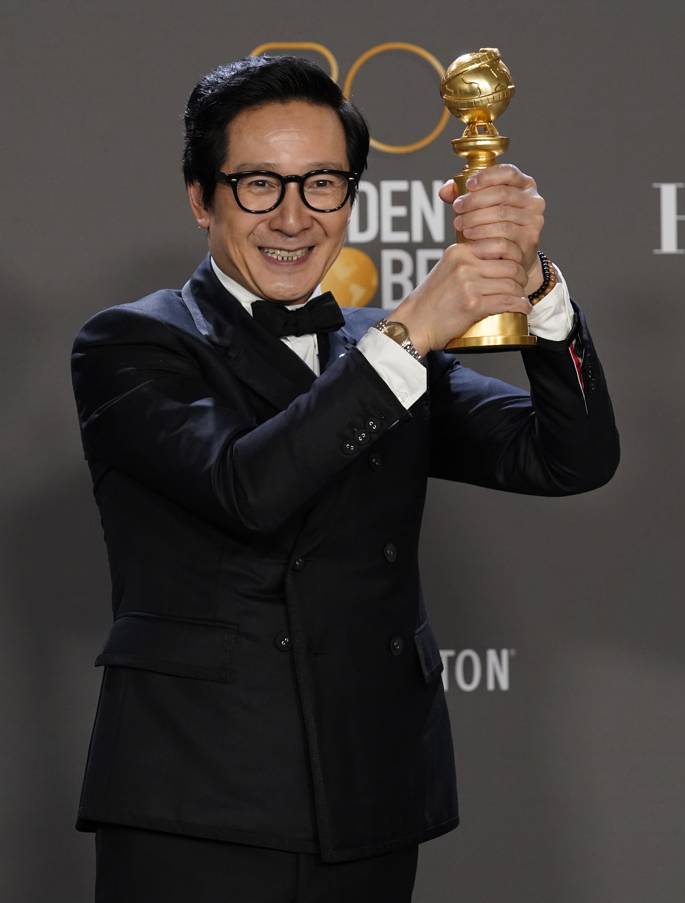 Ke Huy Quan poses in the press room with the award for best performance by an actor in a supporting role in any motion picture for "Everything Everywhere All at Once" at the 80th annual Golden Globe Awards 