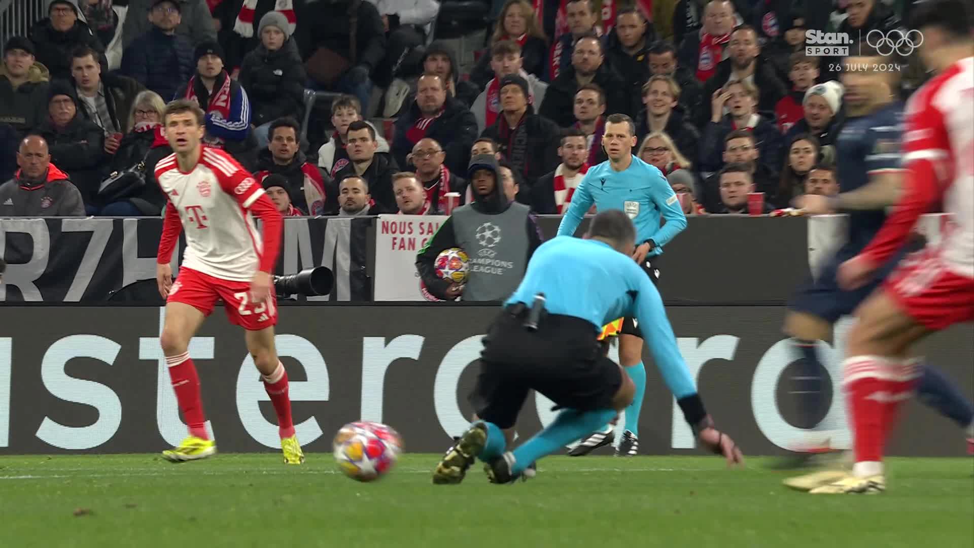 Referee Slavko Vincic slips and gets in the way of a Bayern Munich cross-field kick.