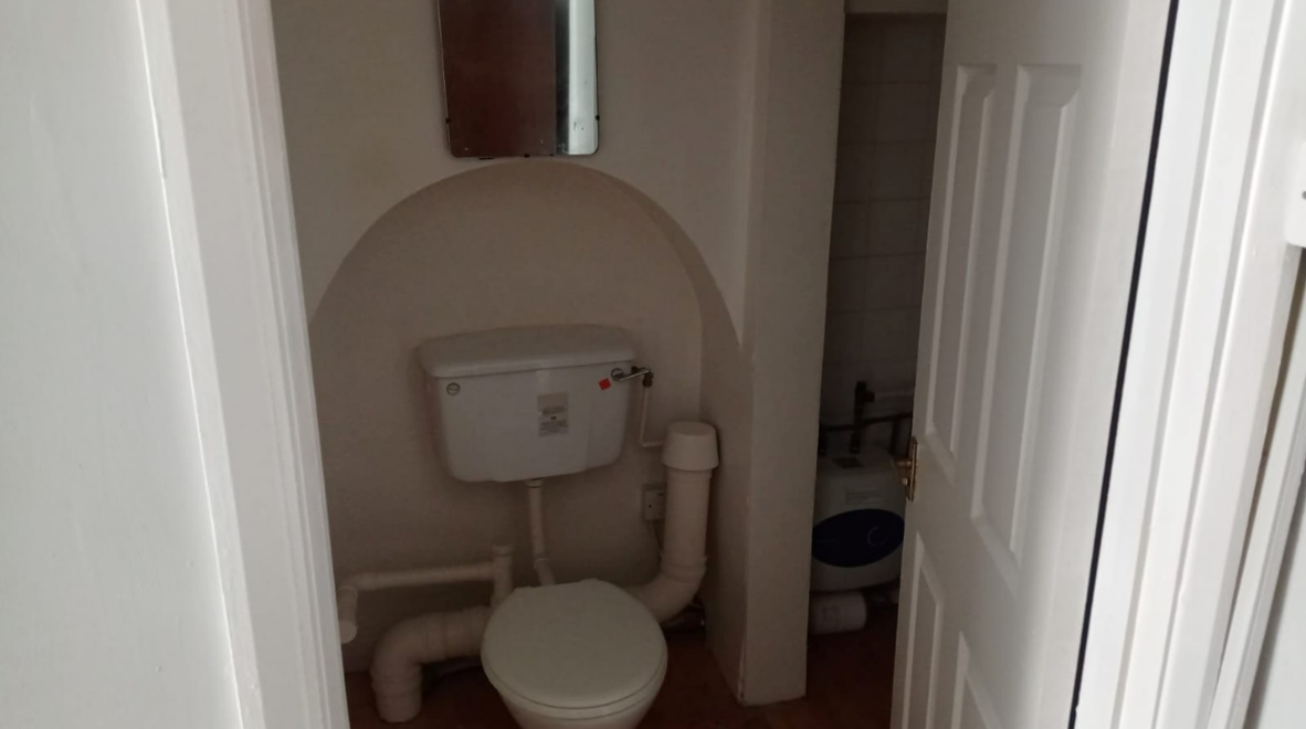 This tiny one-bedroom flat in South London with the bed next to the oven has gone on the market and is asking just under $2k in monthly rent