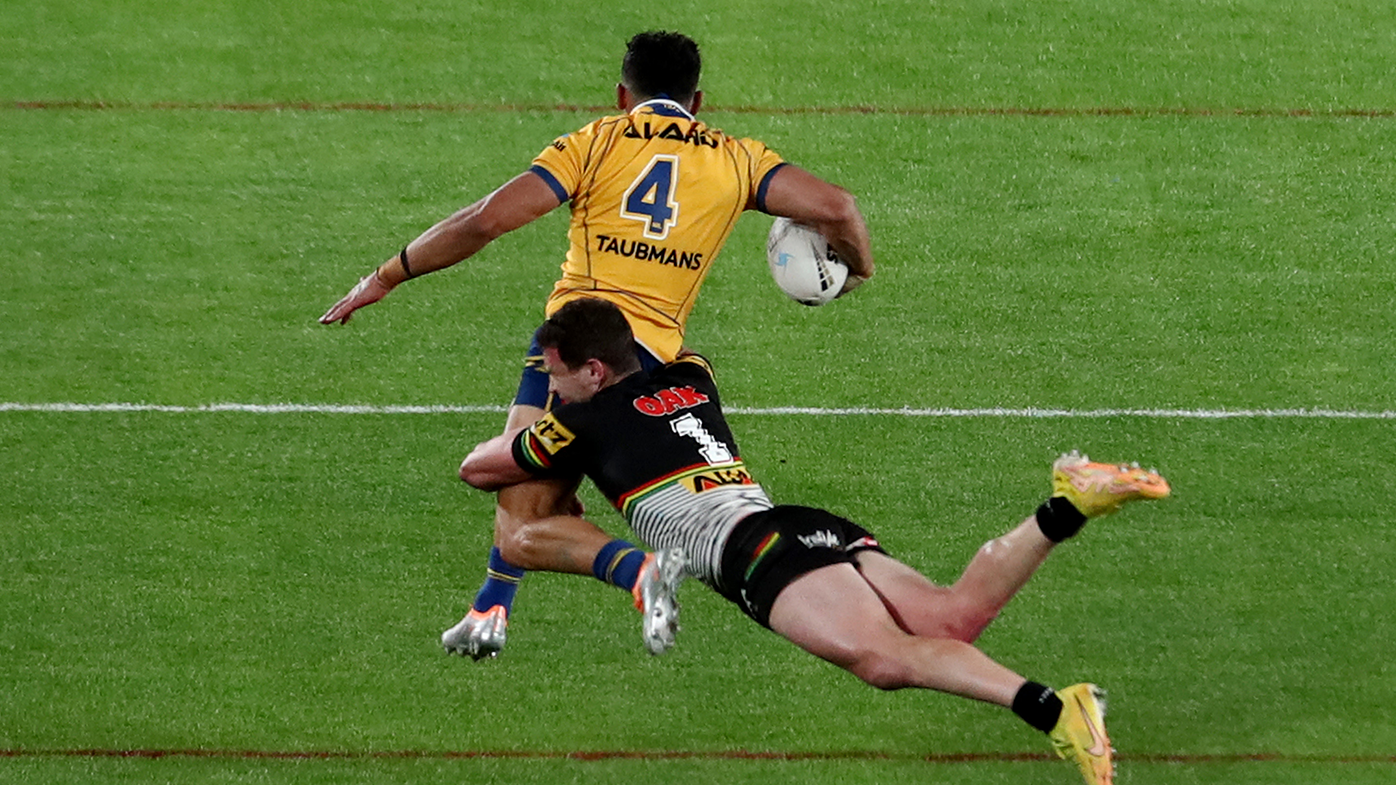 Bailey Simonsson of the Eels is tackled by Dylan Edwards of the Panthers.