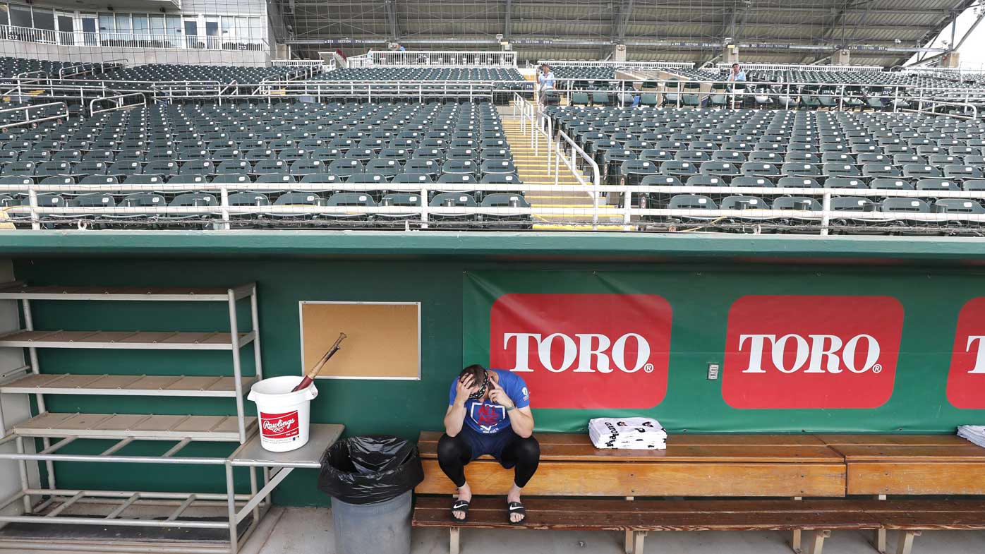 Minnesota Twins catcher Mitch Garver talks on his phone in an empty Hammond Stadium in Fort Myers, Florida, following the cancellation of all spring training games.