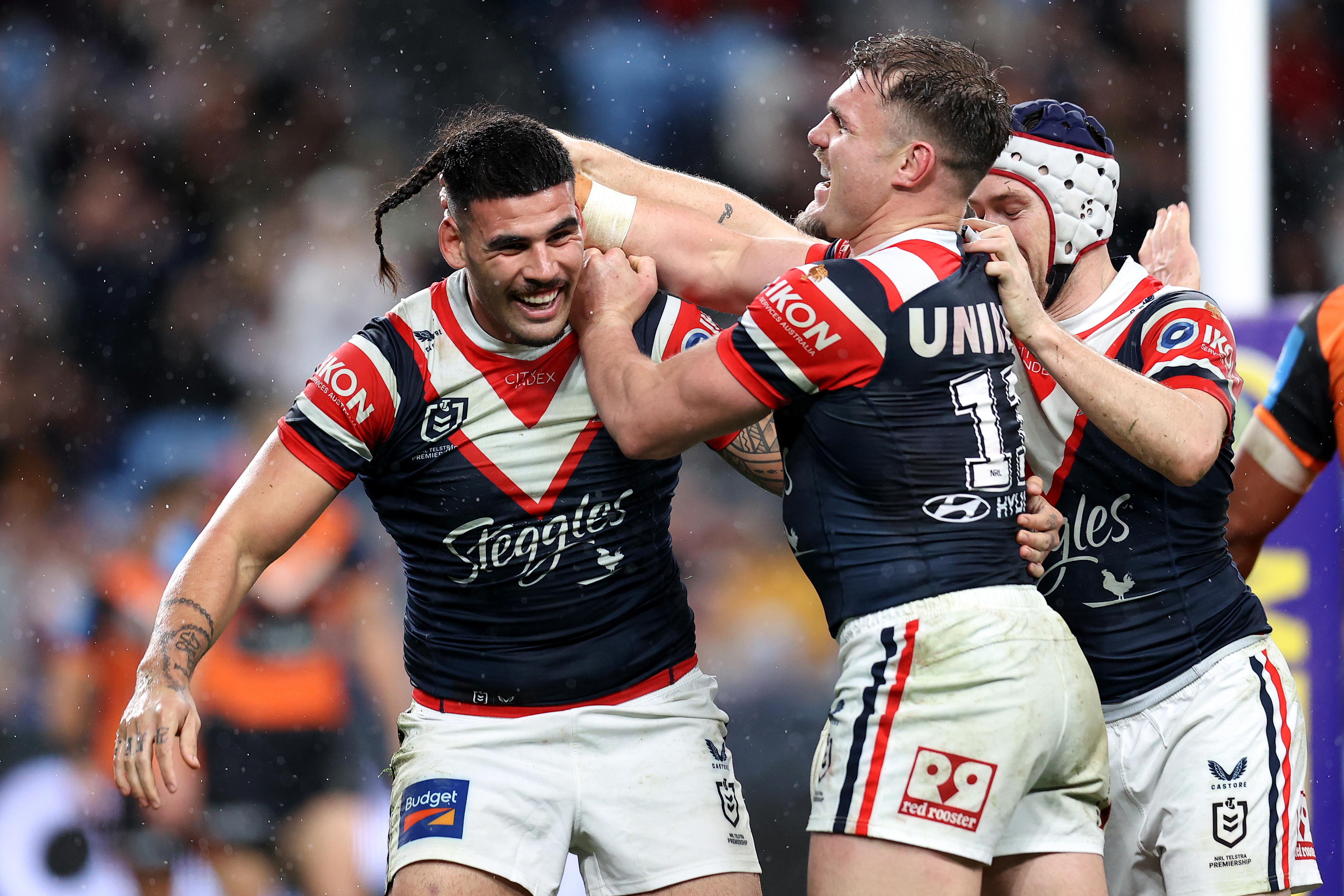 Terrell May of the Roosters celebrates with teammates after scoring a try.