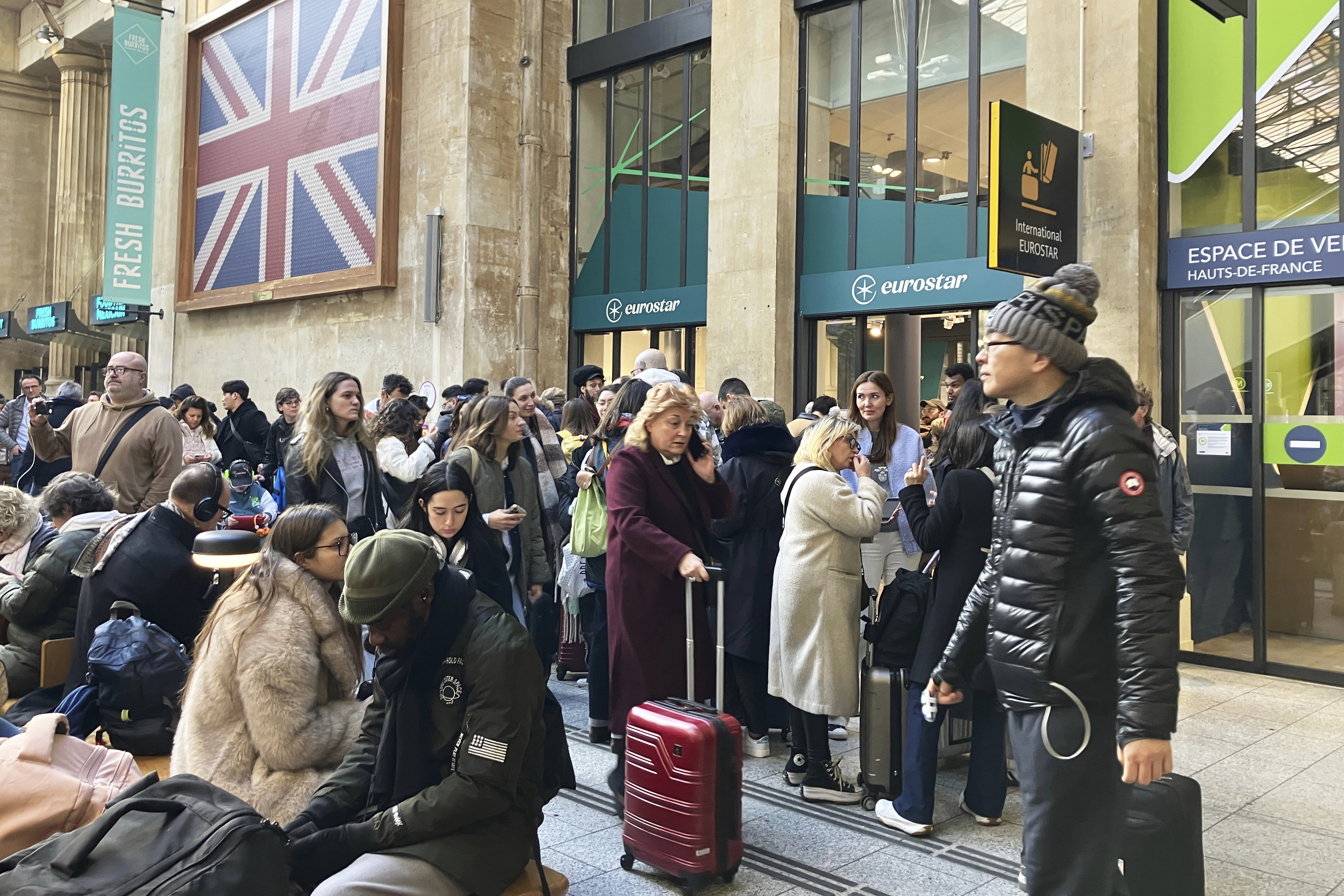 Passengers wait as Eurostar trains to London and all trains heading to northern France have been brought to a halt