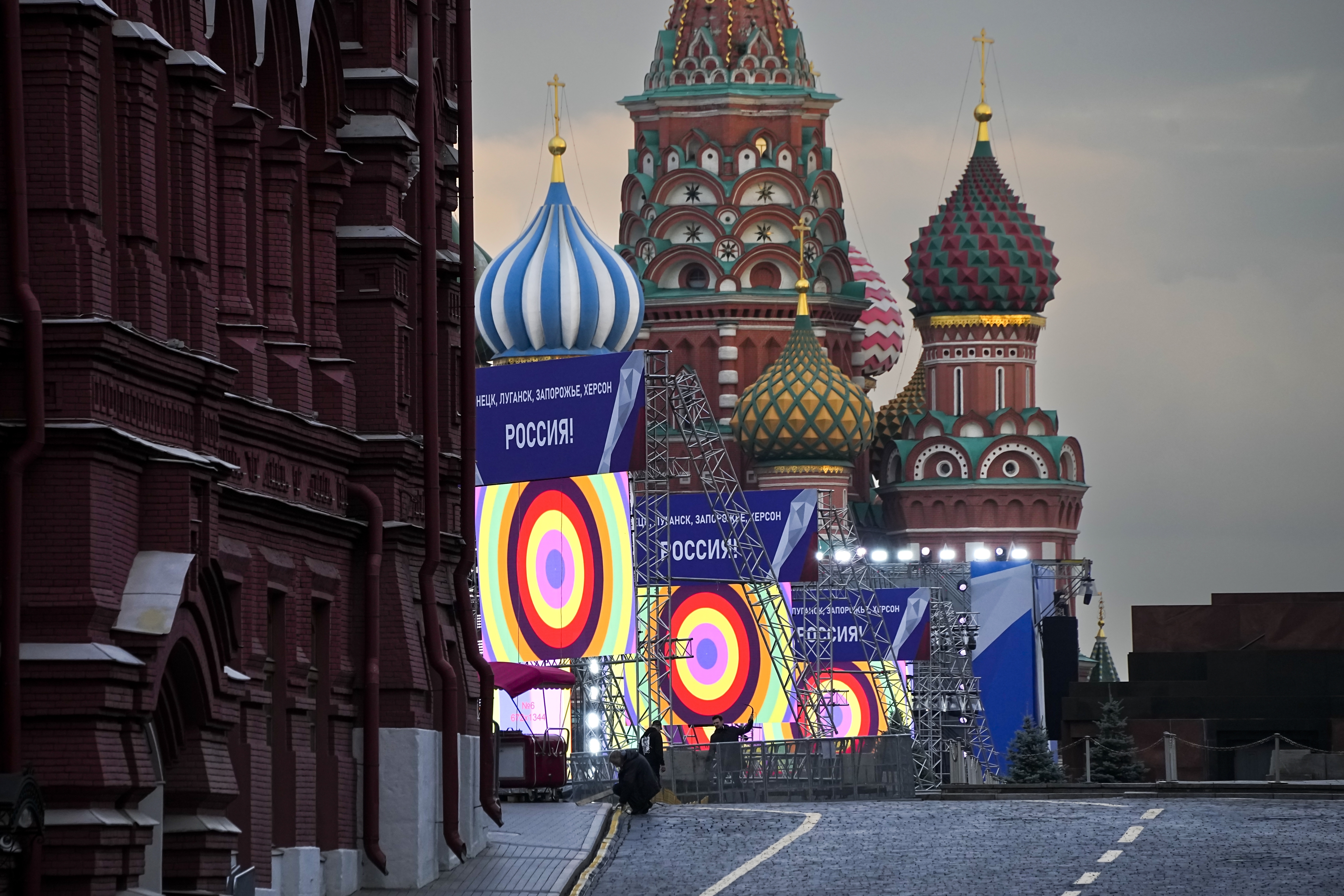 People make preparations for a concert at the Red Square, with constructions reading the words ''Donetsk, Luhansk, Zaporizhzhia, Kherson, Russia'', and the St. Basil's Cathedral and Lenin Mausoleum on the background, in Moscow, Russia, Thursday, Sept. 29, 2022. The Kremlin said that Russian President Vladimir Putin and the leaders of the four regions of Ukraine that held a referendum on joining Russia will attend a ceremony to sign documents on the regions' incorporation into Russia, which will 